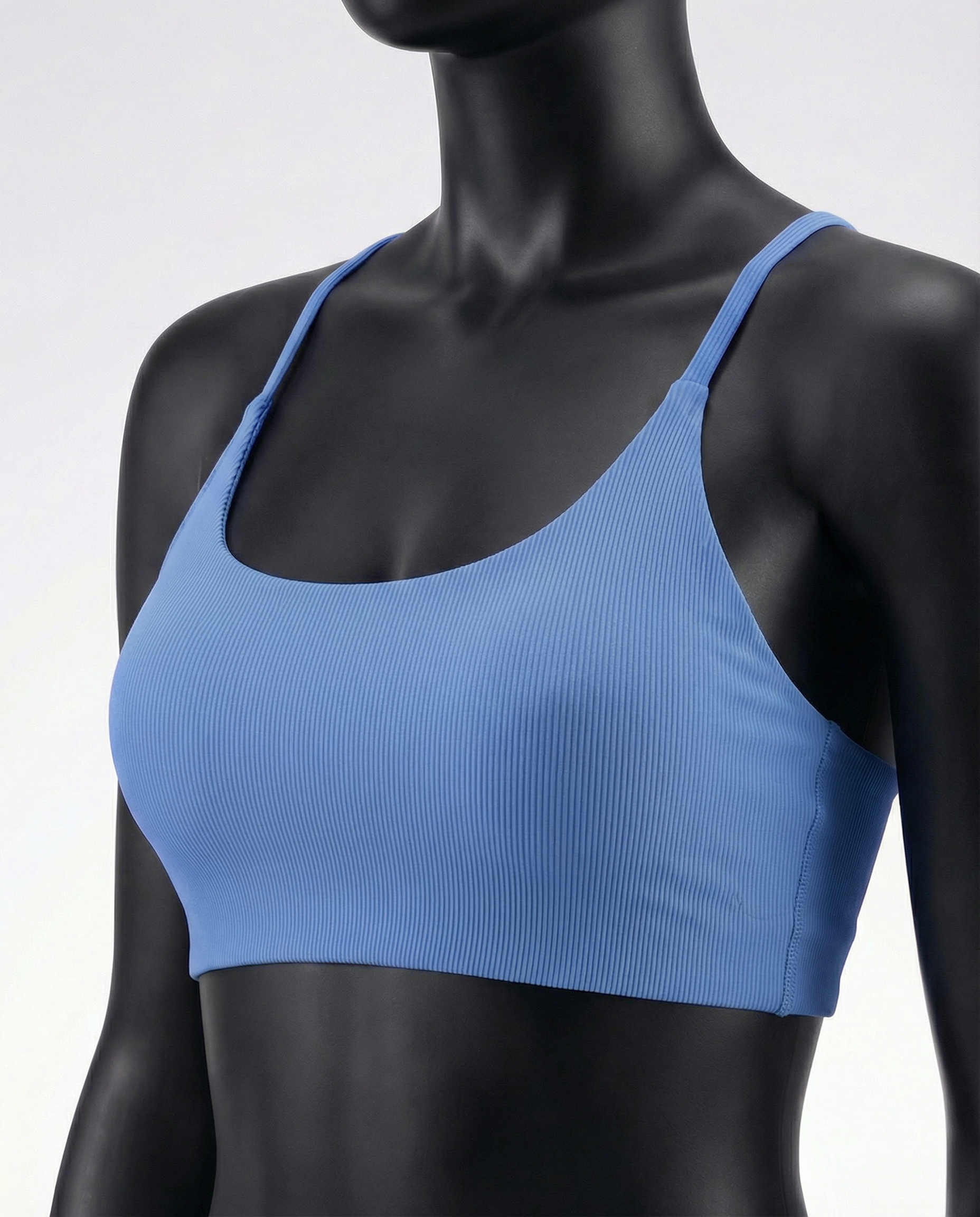 Mannequin wearing a blue sports bra and leggings on a white background