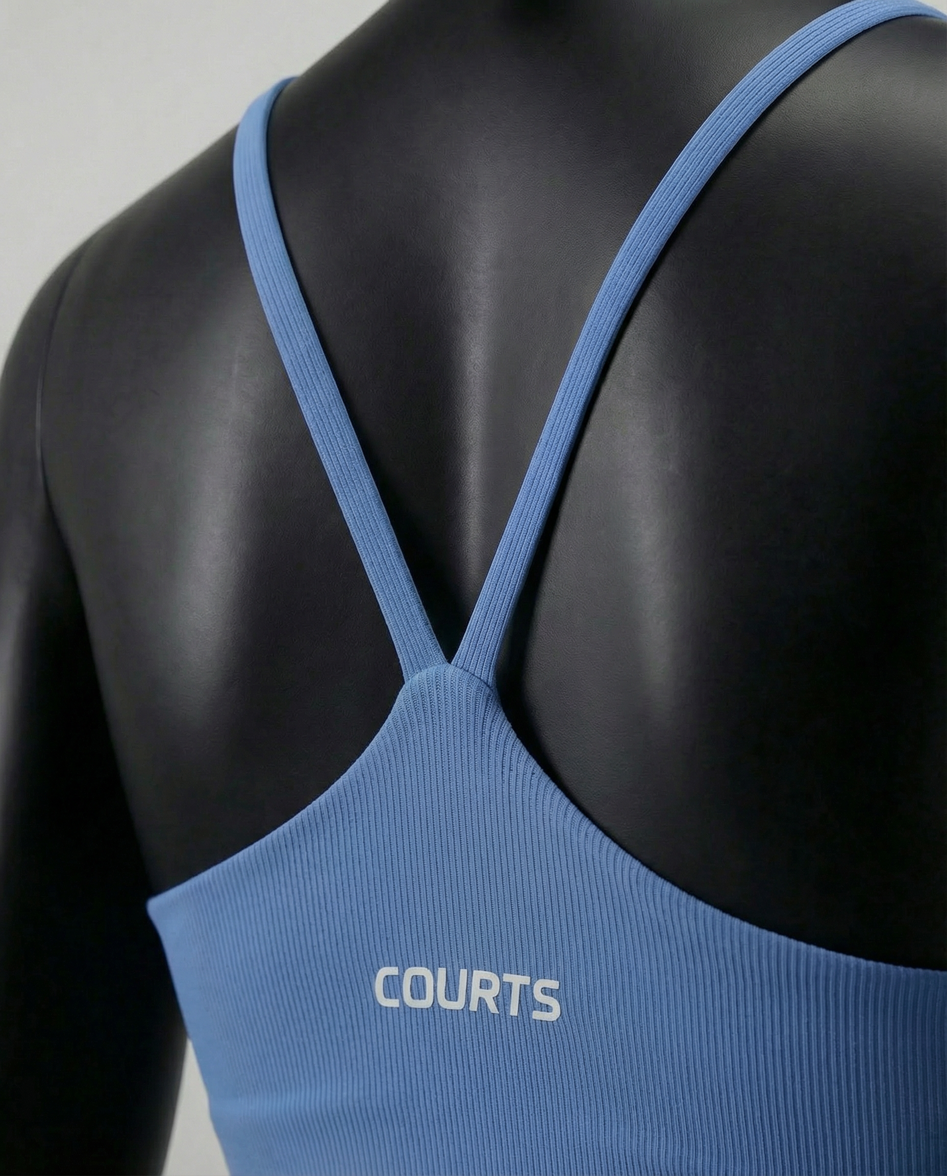 Mannequin wearing a blue sports bra and leggings on a white background