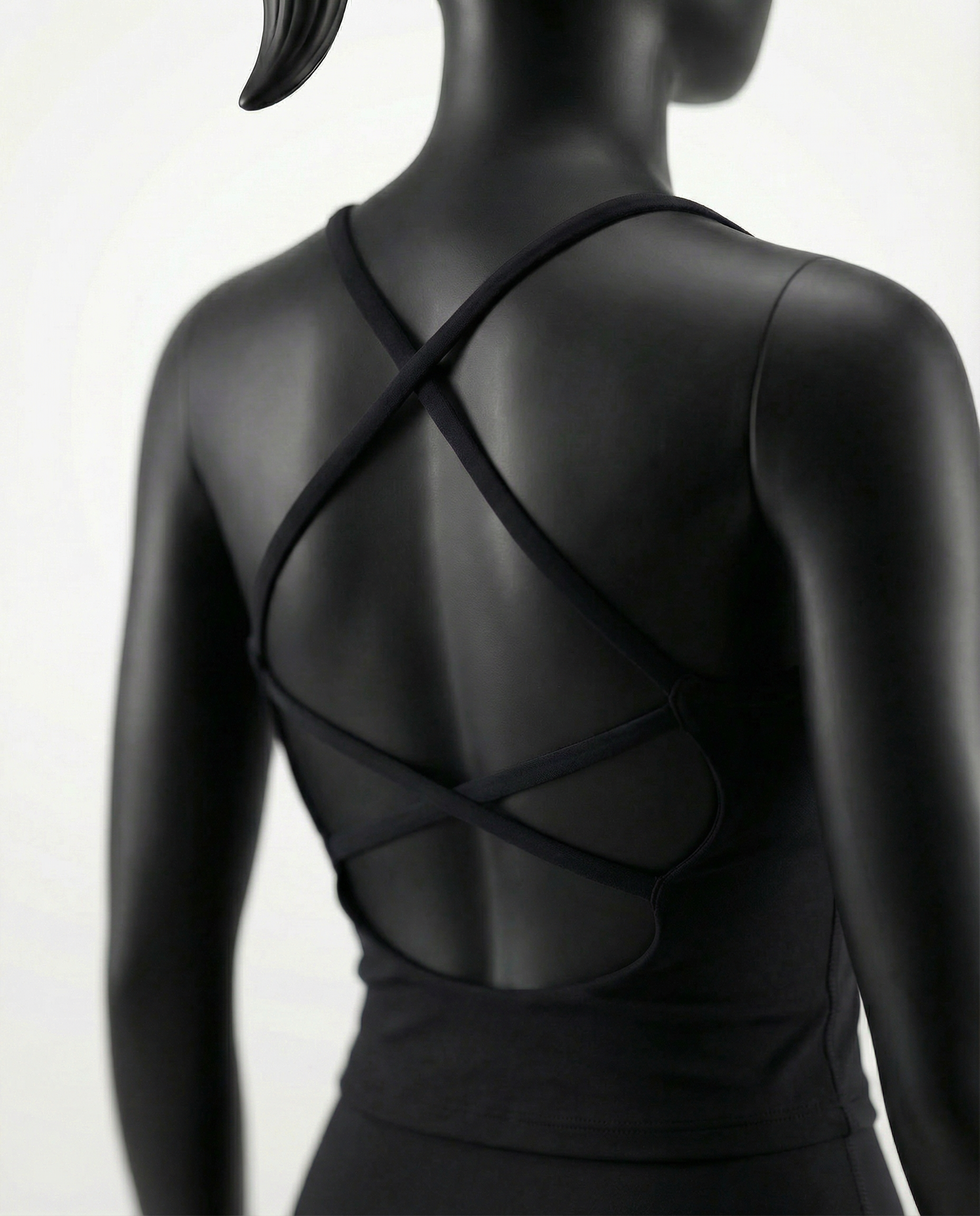 Courts black athletic crop top and leggings on a mannequin against a white background