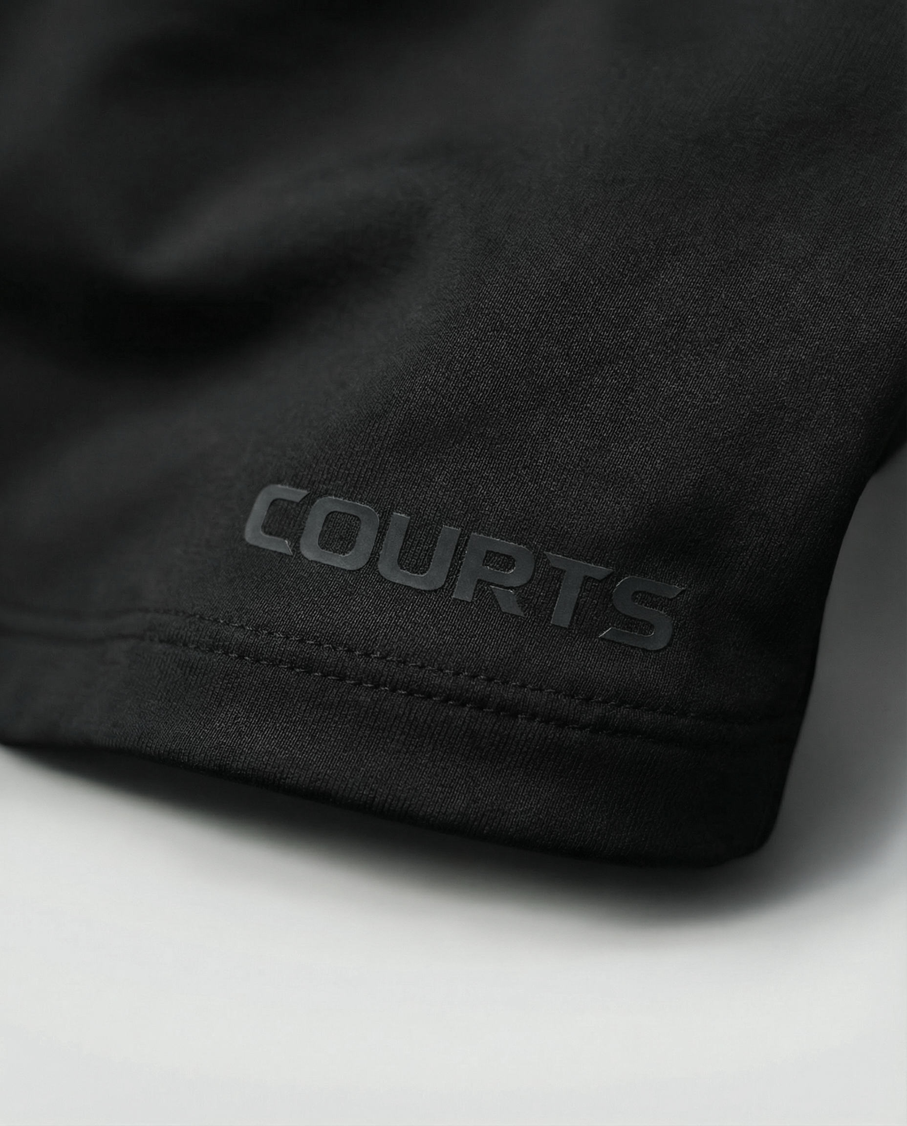 Courts black athletic crop top and leggings on a mannequin against a white background