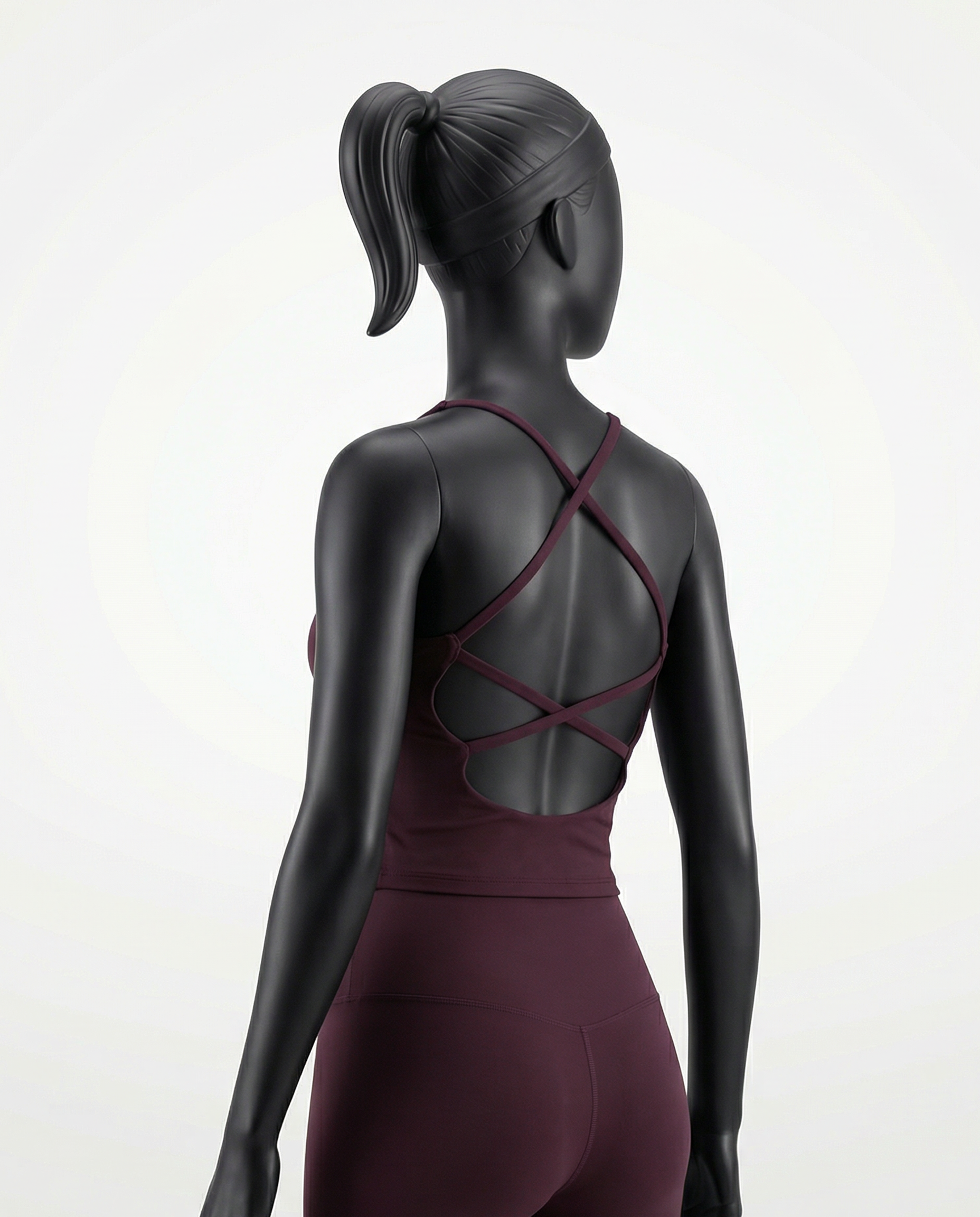 Courts grape purple - maroon athletic crop top and leggings on a mannequin against a white background