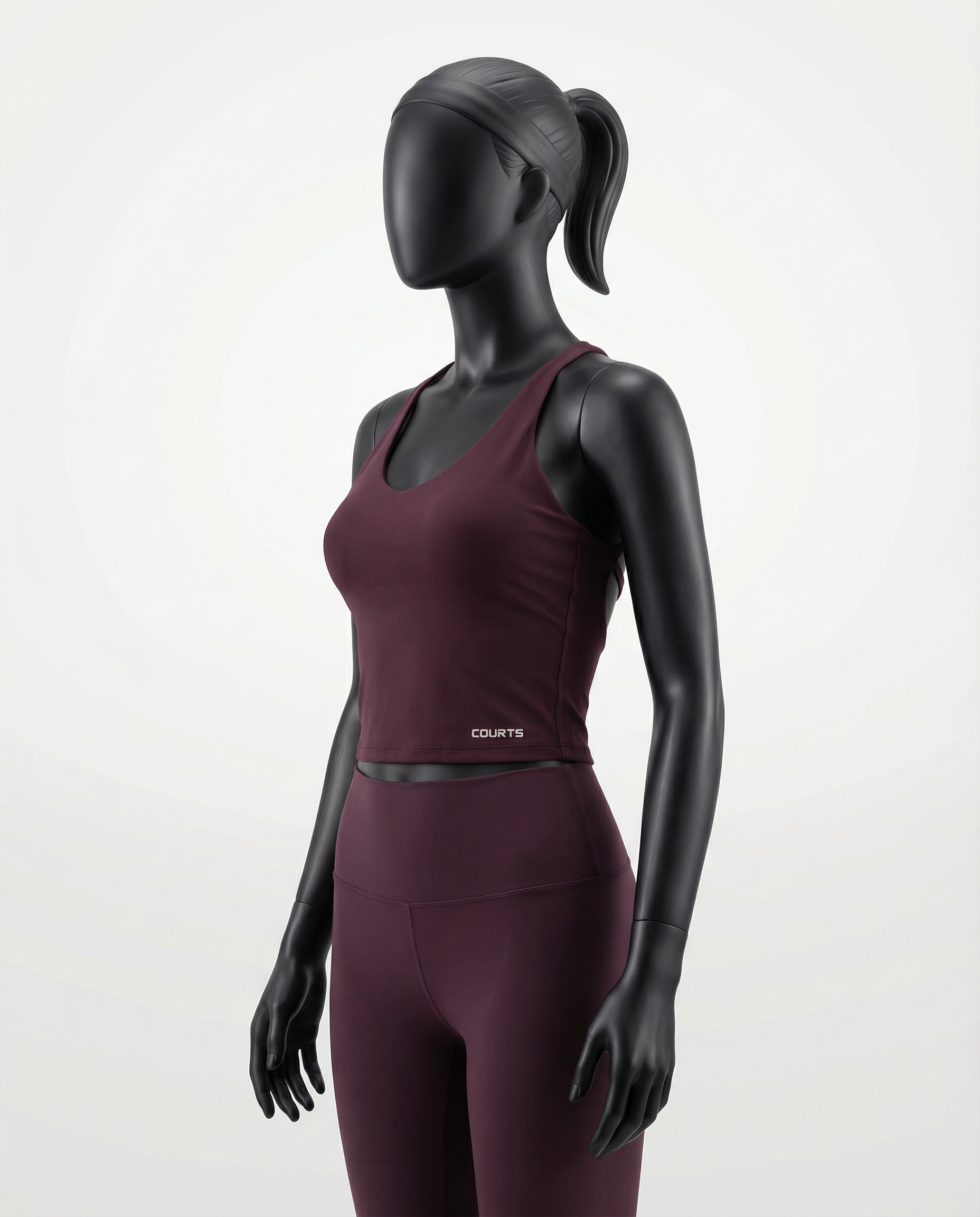 Courts grape purple - maroon athletic crop top and leggings on a mannequin against a white background