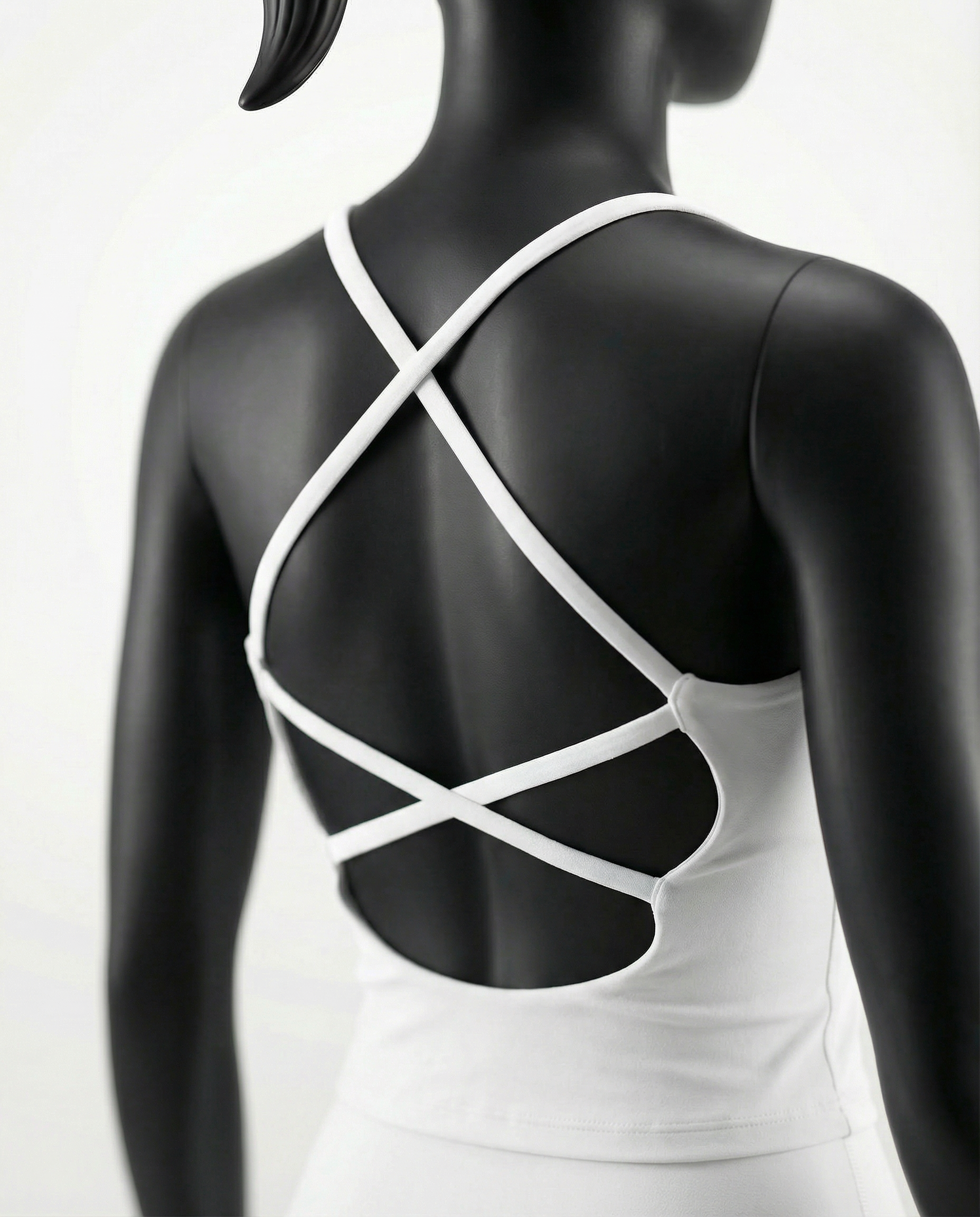 Courts white athletic crop top and leggings on a mannequin against a white background