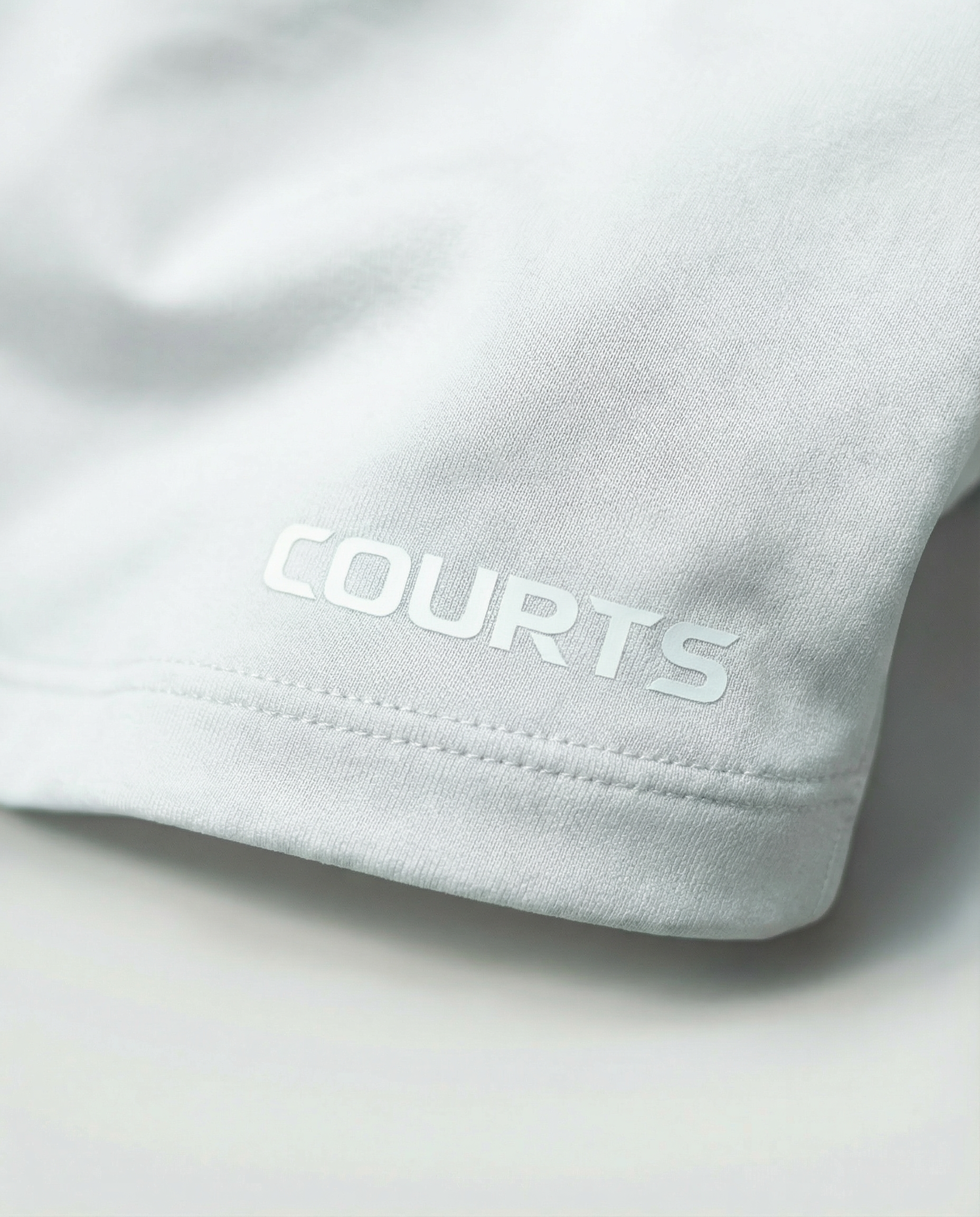 Courts white athletic crop top and leggings on a mannequin against a white background