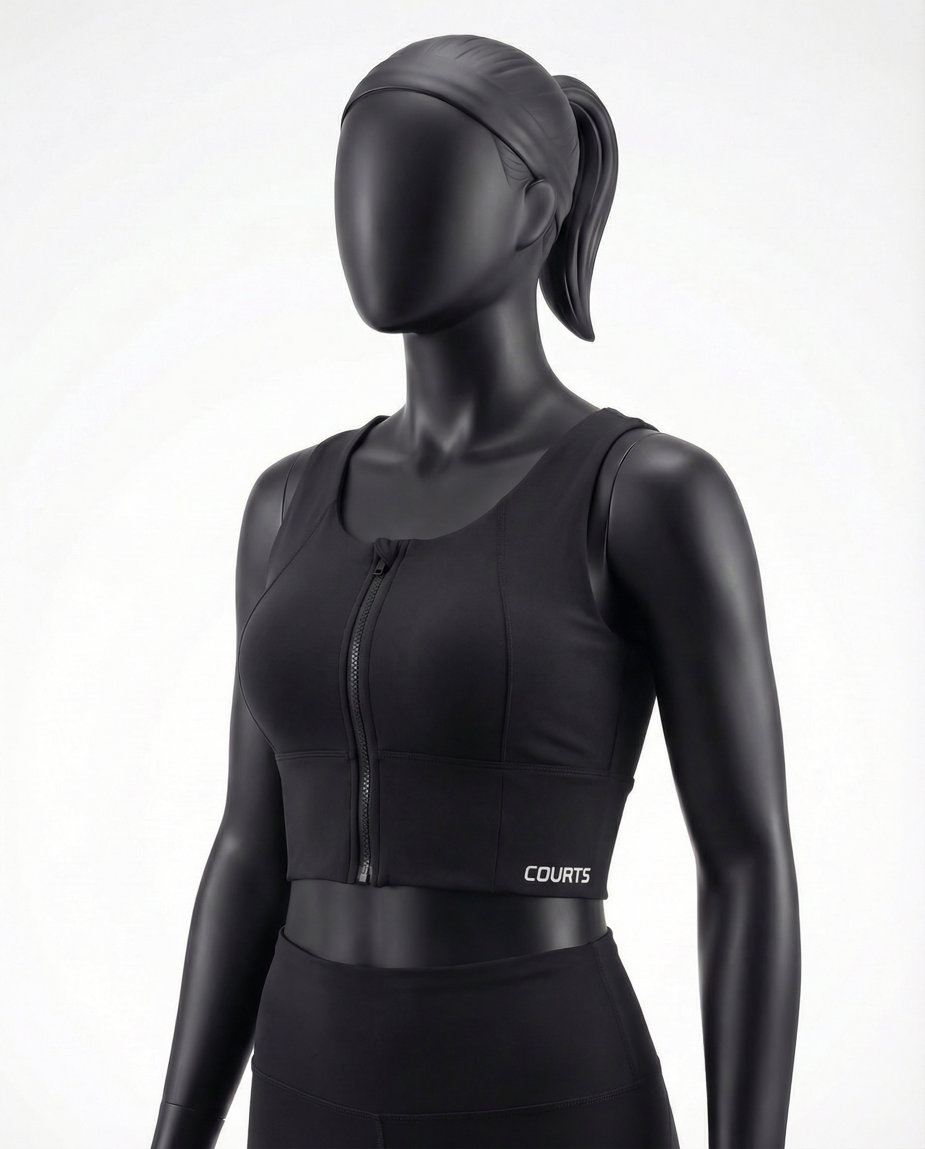 Black athletic top bra with a zipper on a mannequin against a white background
Courts Sport