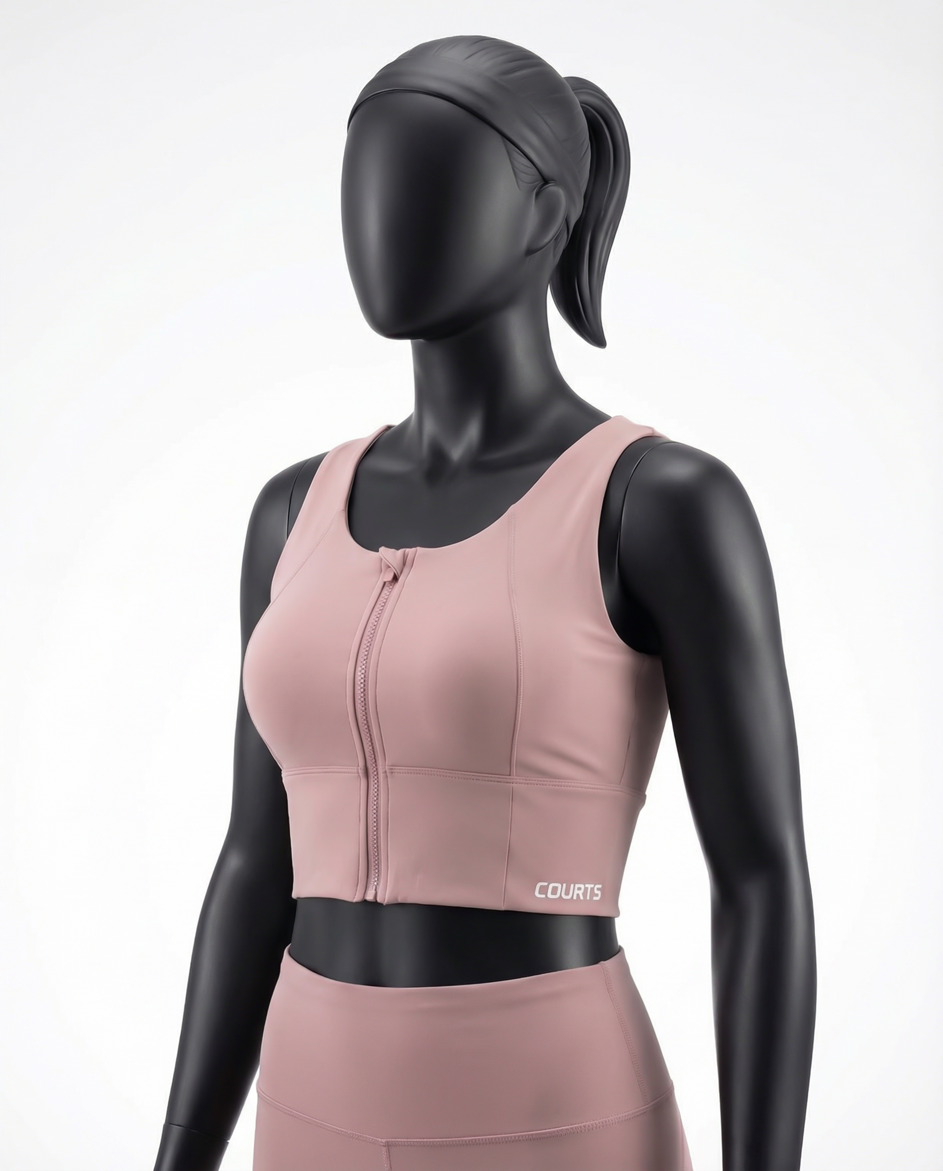 Pink athletic top bra with a black belt on a mannequin against a white background
Courts Sport