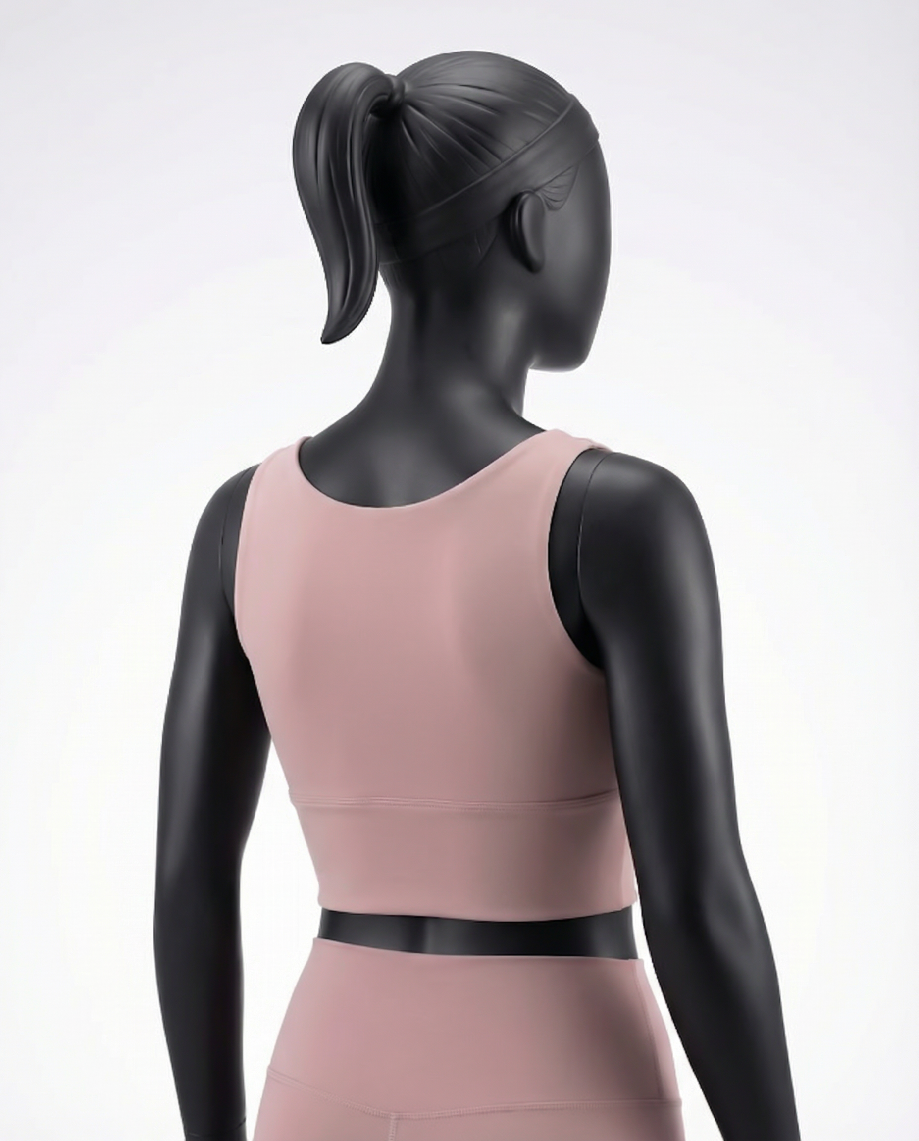 Pink athletic top bra with a black belt on a mannequin against a white background
Courts Sport