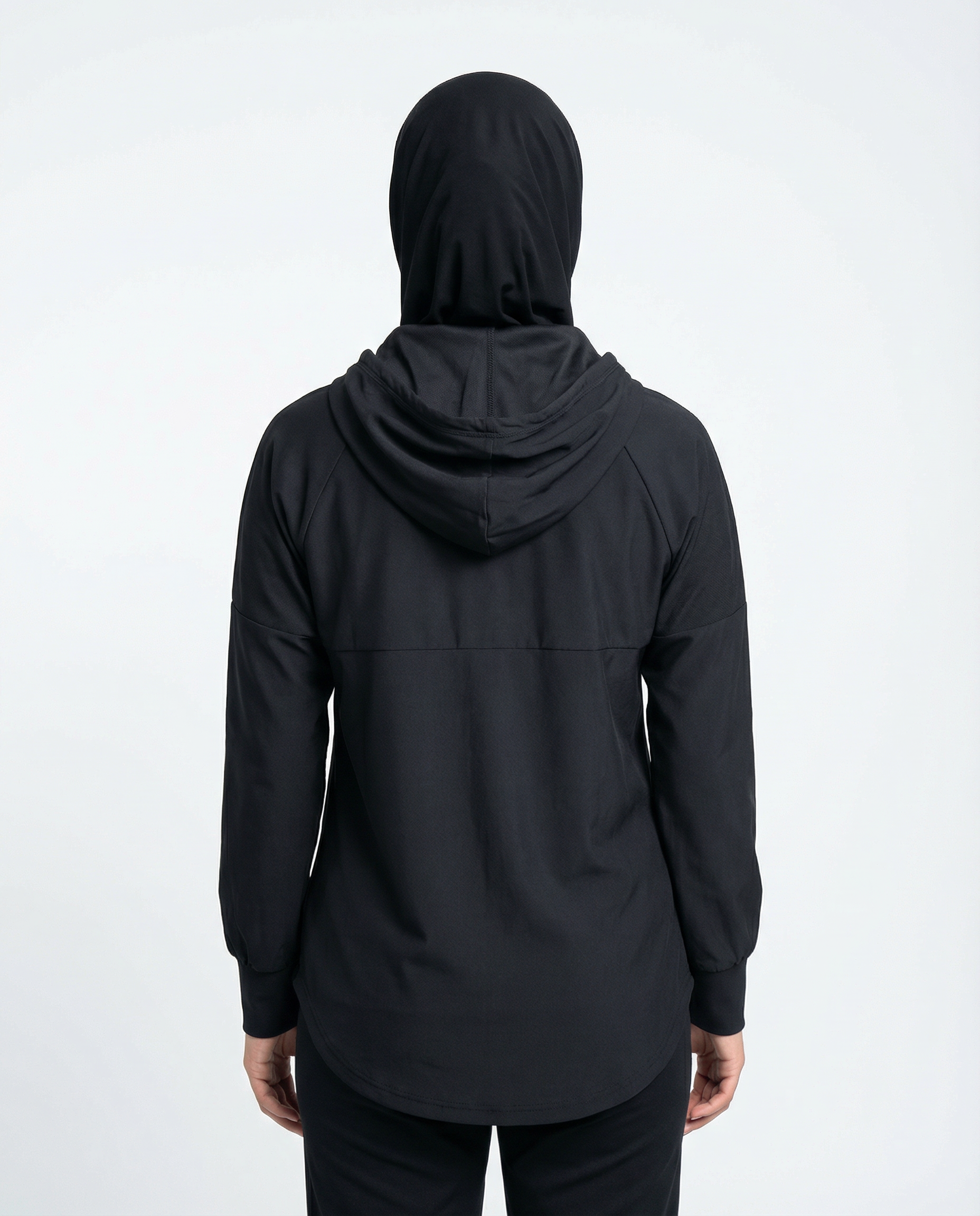 Person wearing a black hooded jacket with a logo on a white background
