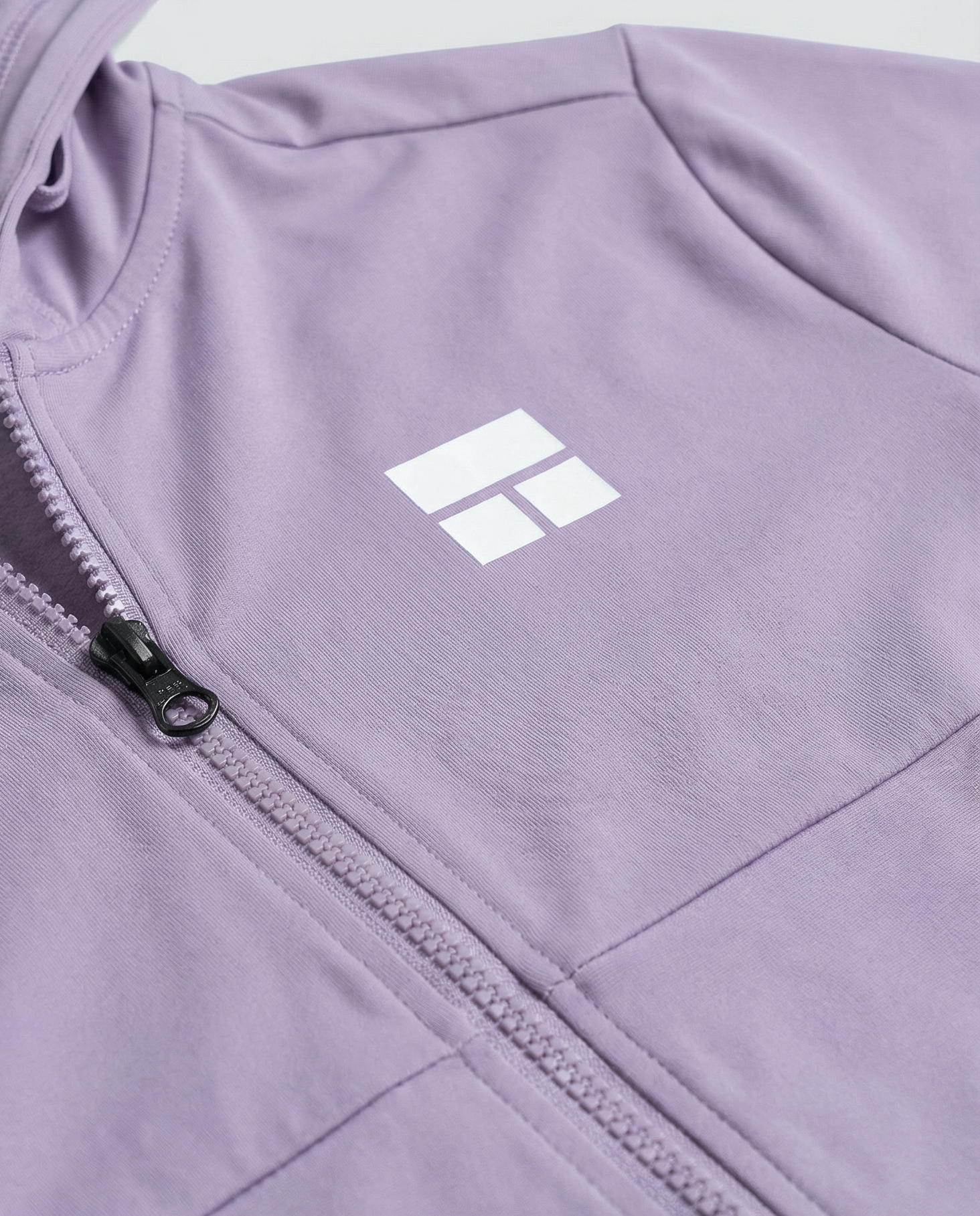 Woman wearing a purple hoodie with a brand logo on a white background