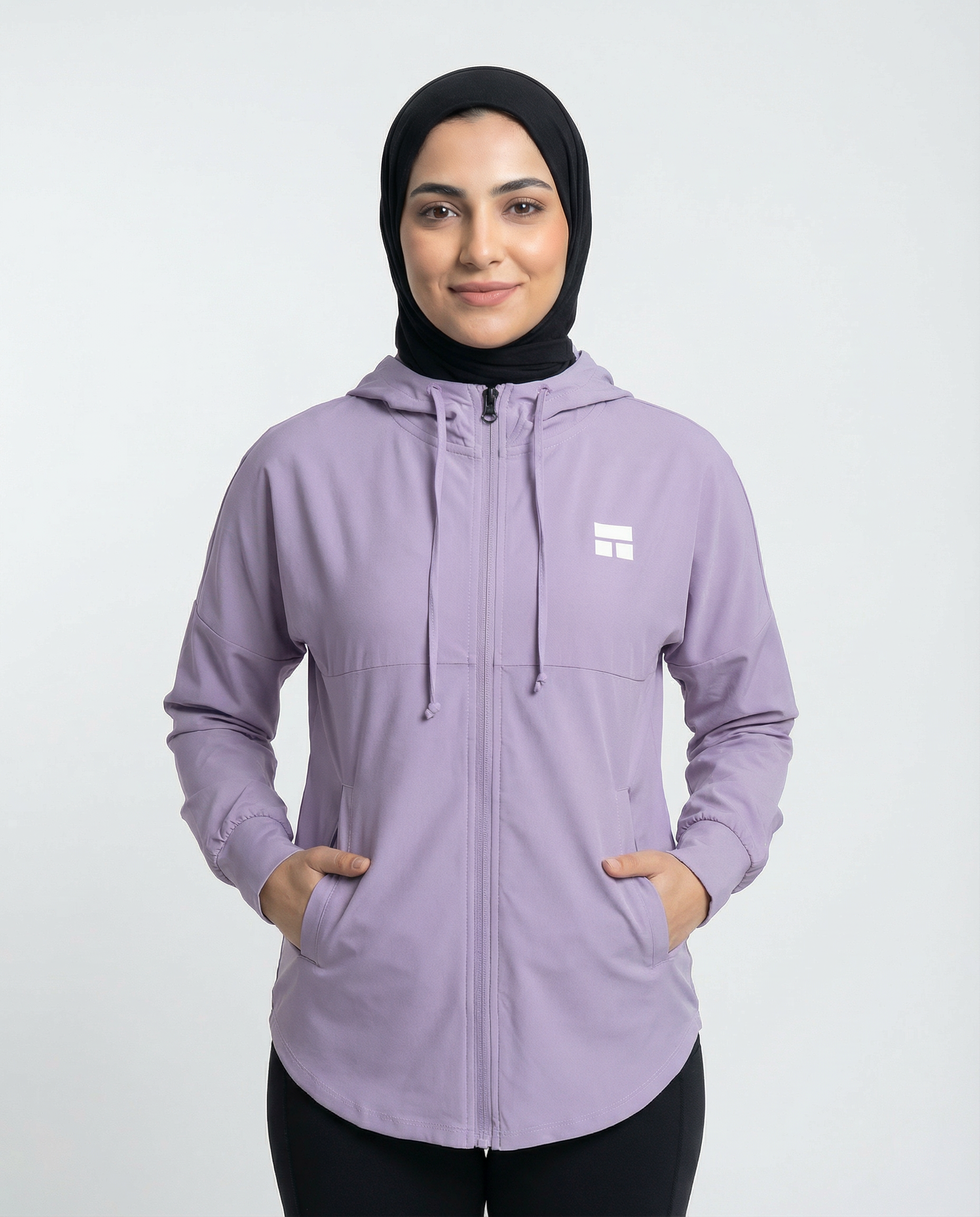 Woman wearing a purple hoodie with a brand logo on a white background
