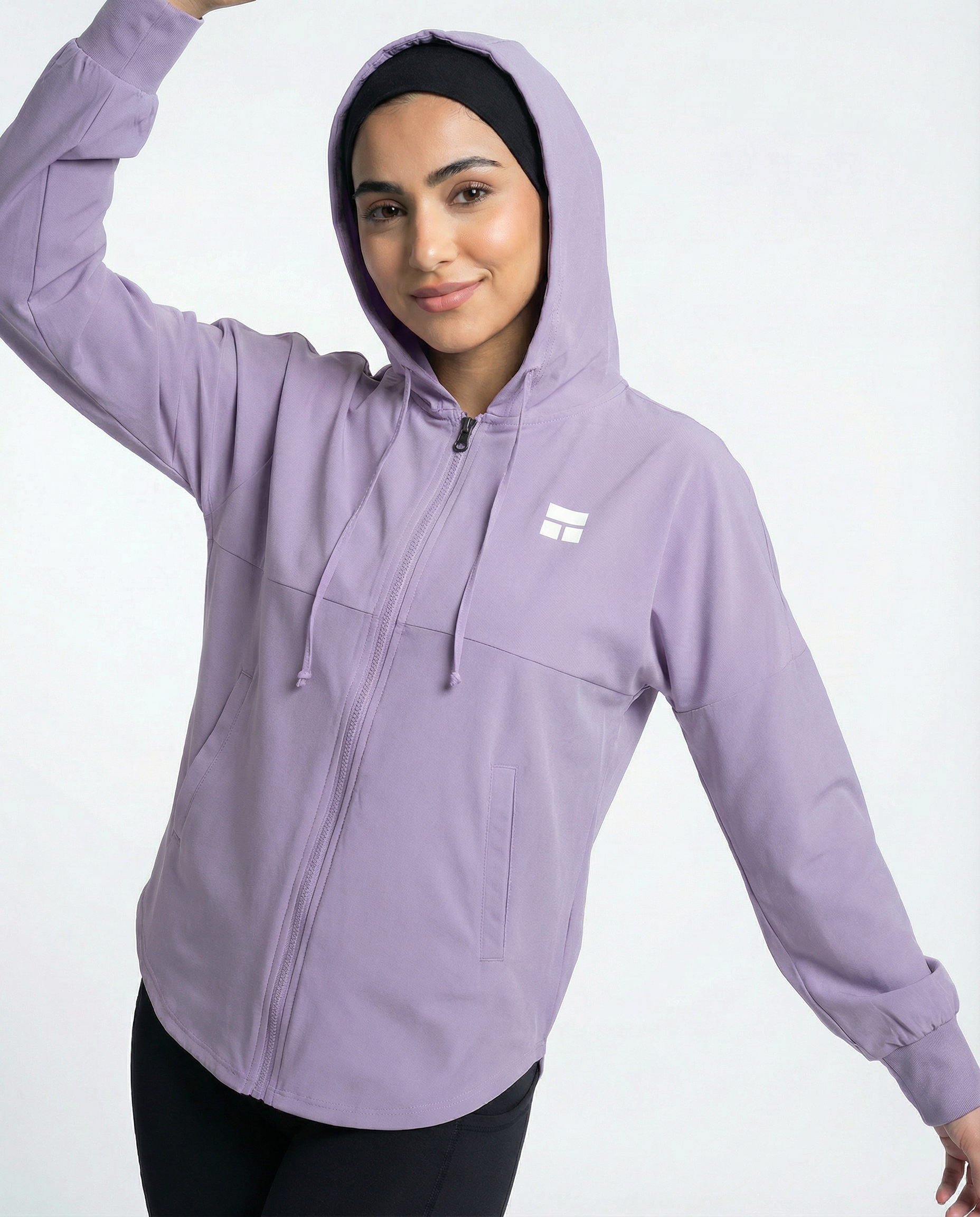 Woman wearing a purple hoodie with a brand logo on a white background