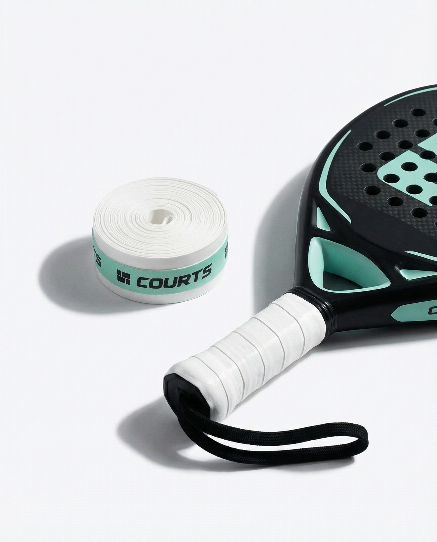 black padel and tennis racket handle with white grip and 'COURTS' branding on a white background