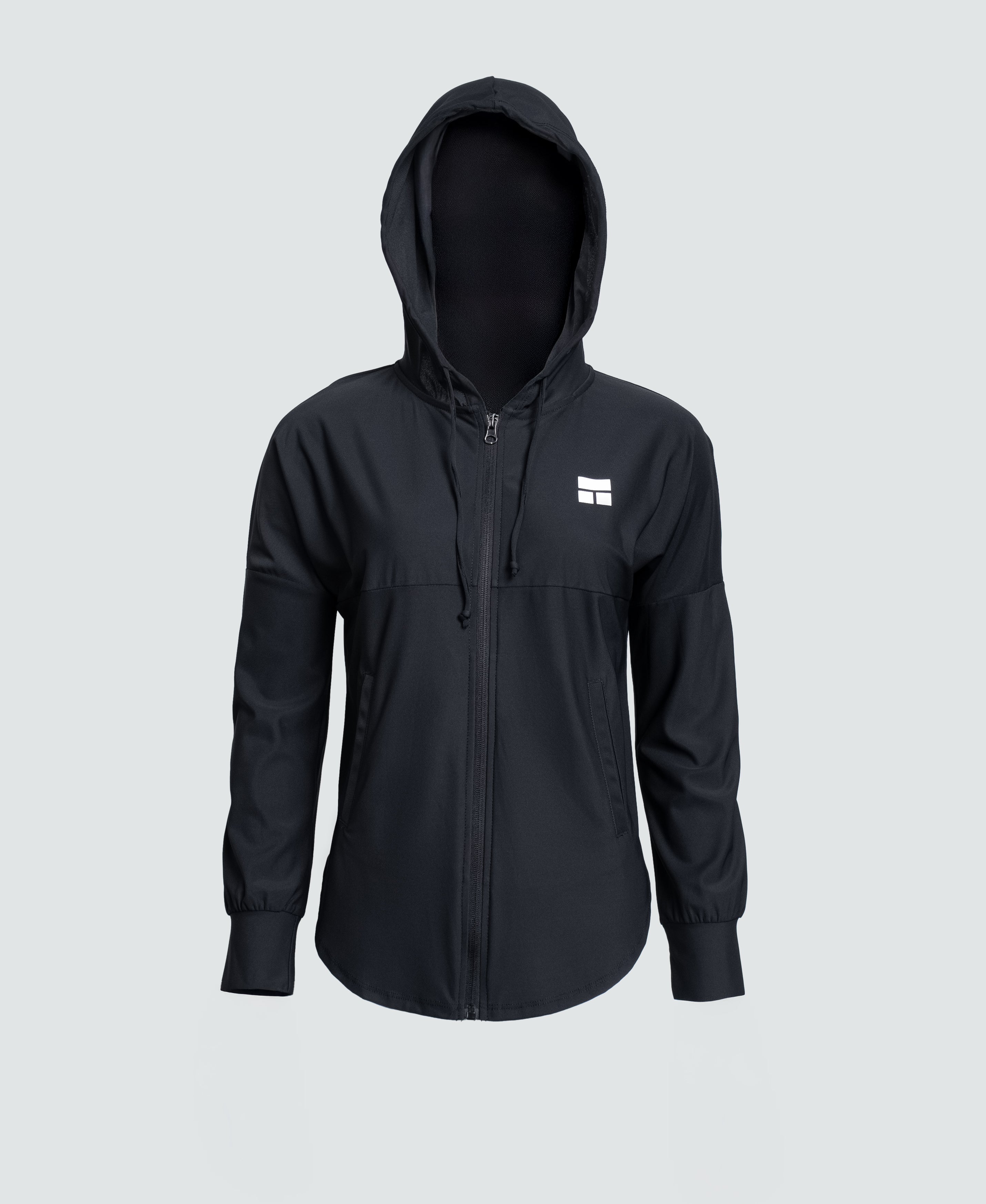 Person wearing a black hooded jacket with a logo on a white background