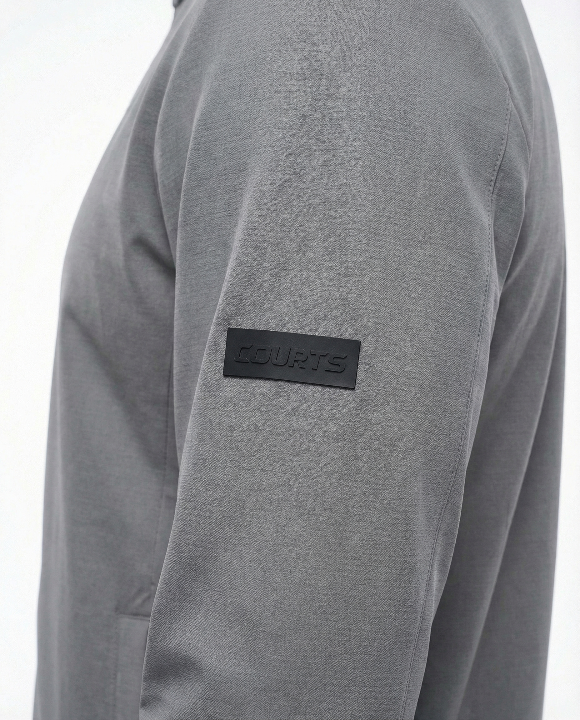 Man wearing a grey jacket on a white background
Courts Sport