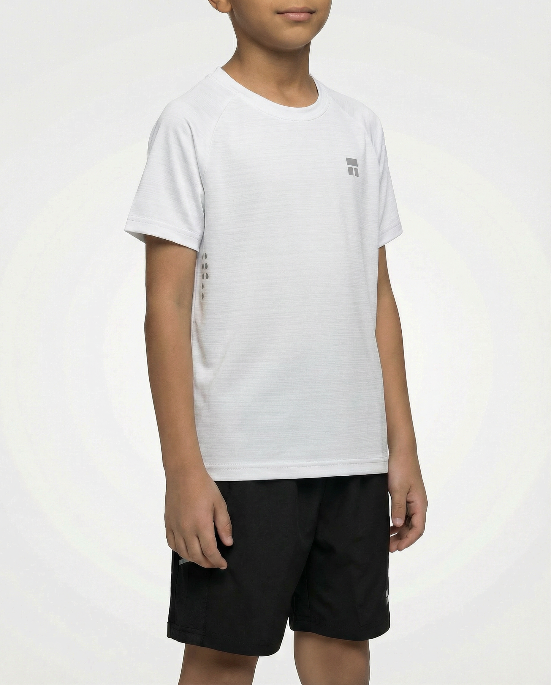 Child wearing a Courts sport white t-shirt and black shorts on a white background