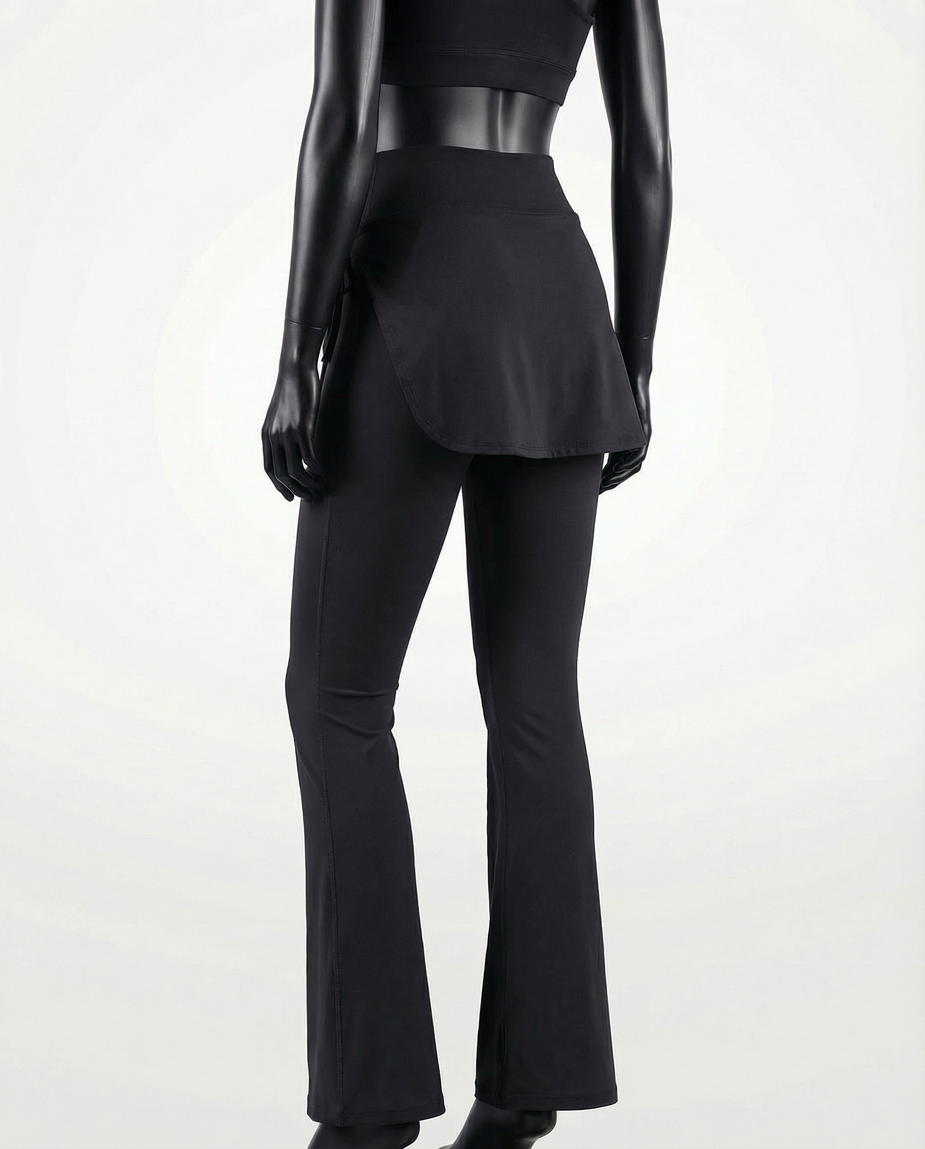 Mannequin wearing a black skirt and pants with 'Courts' branding on a white background