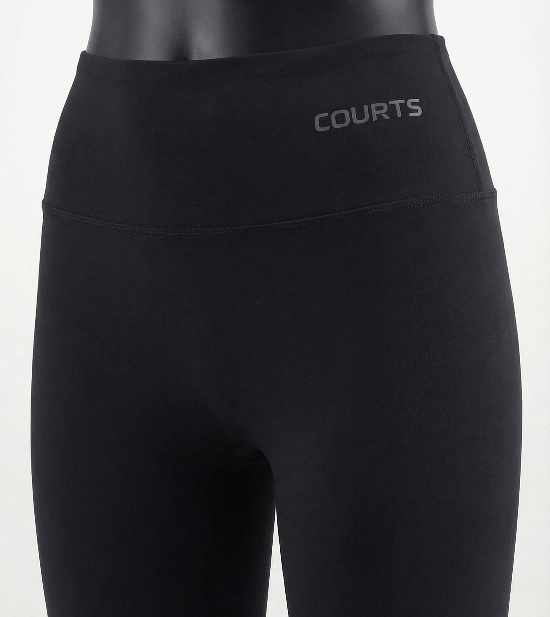 Mannequin wearing a black skirt and pants with 'Courts' branding on a white background