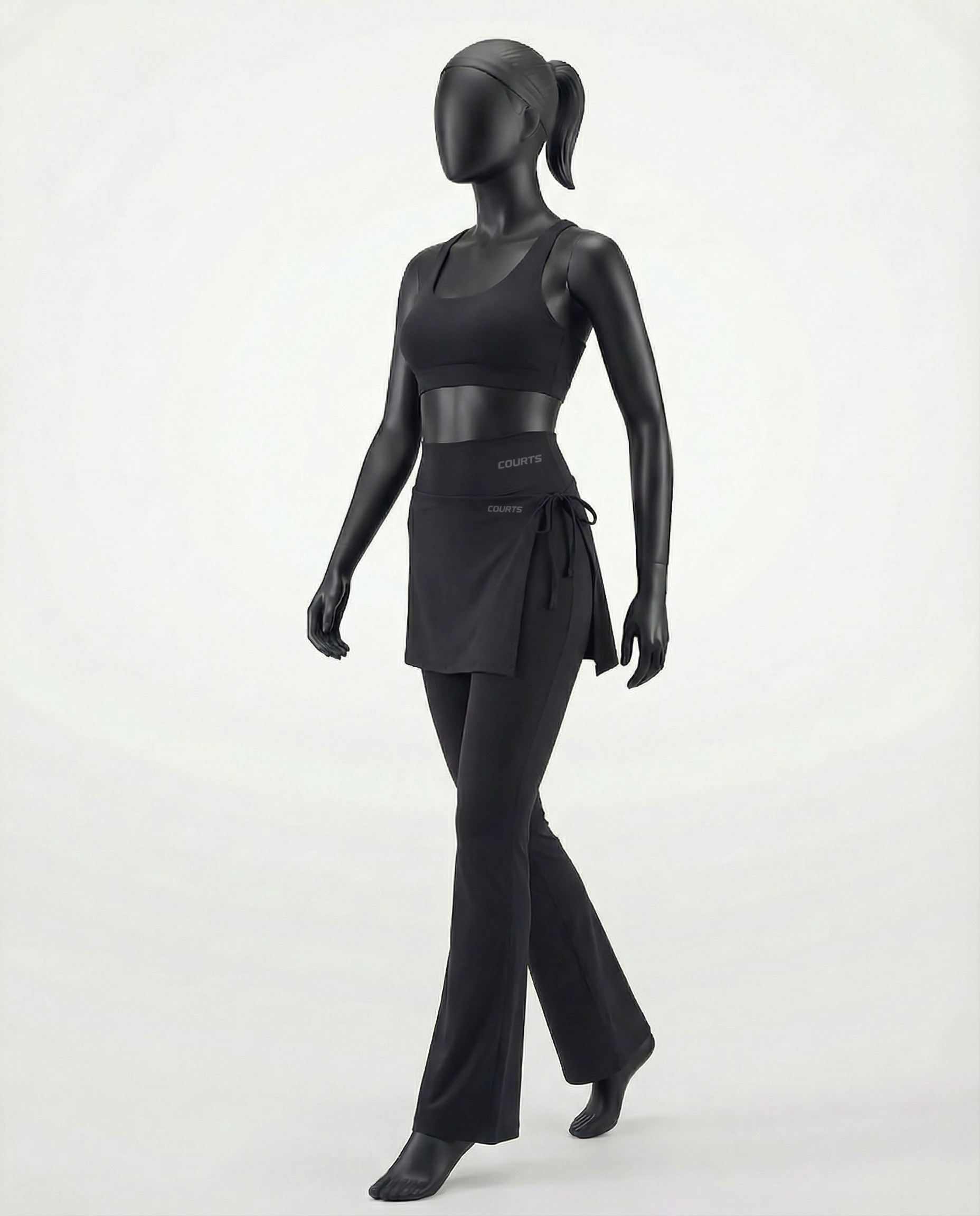 Mannequin wearing a black skirt and pants with 'Courts' branding on a white background