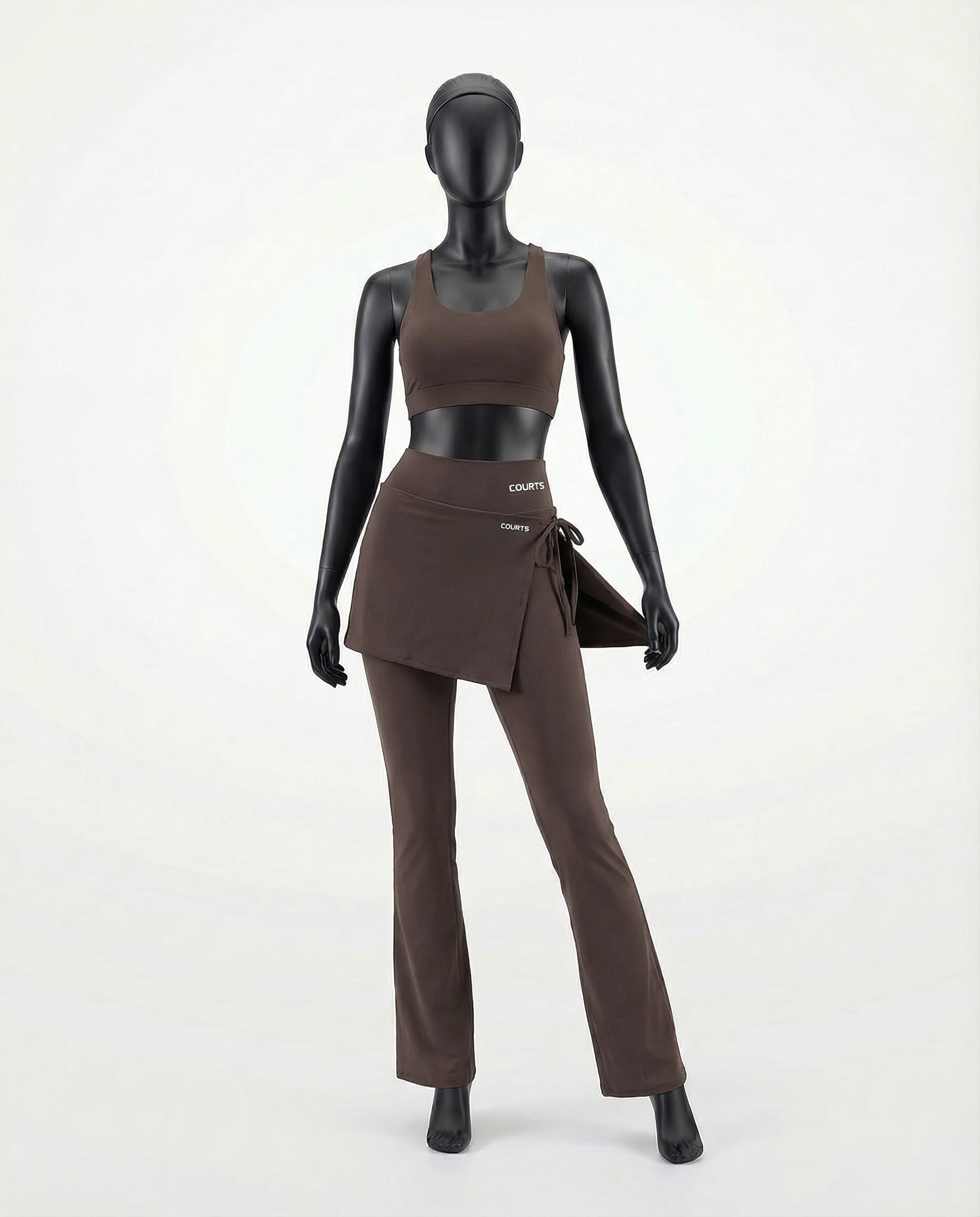 Mannequin wearing a brown skirt and pants with 'Courts' branding on a white background