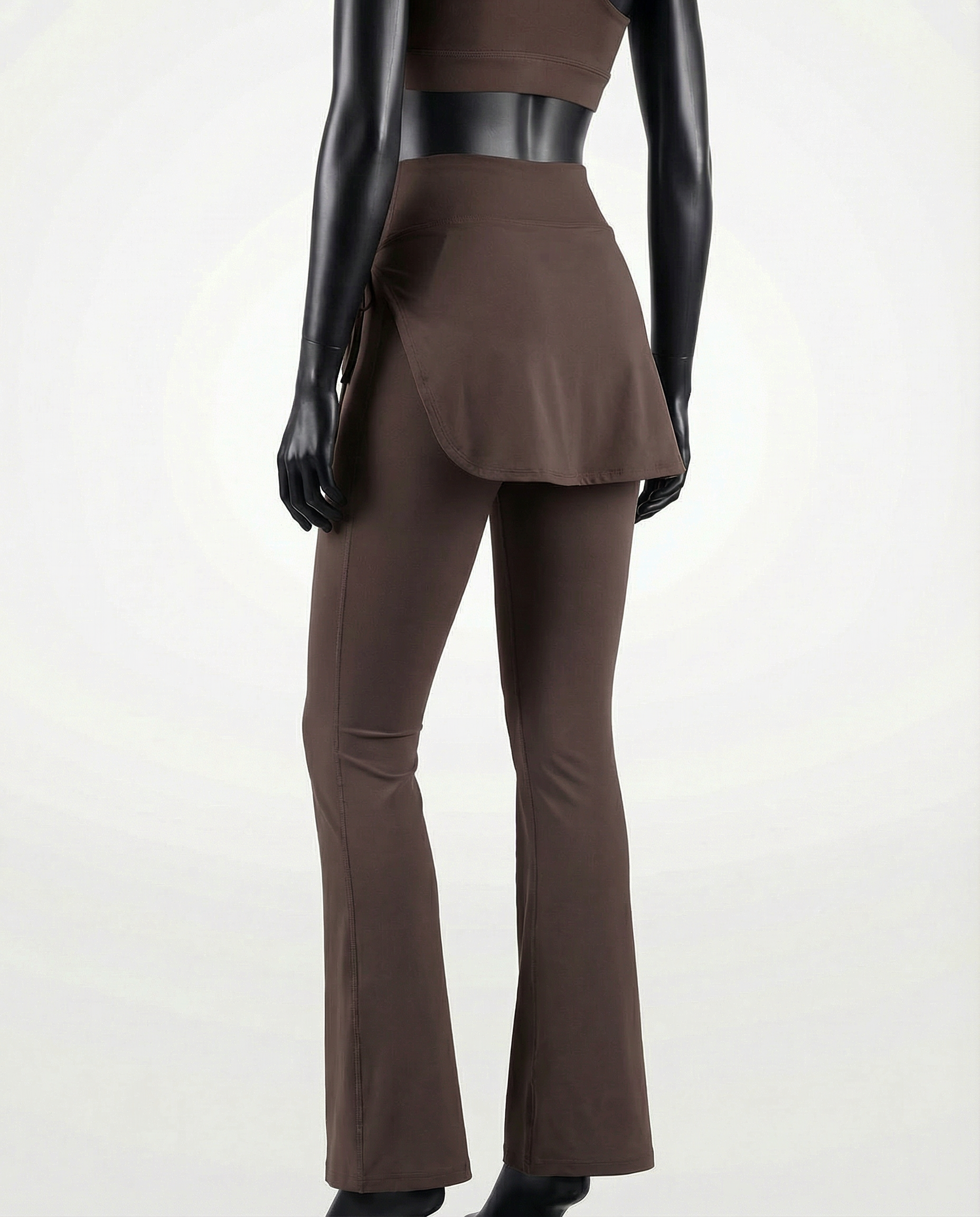Mannequin wearing a brown skirt and pants with 'Courts' branding on a white background