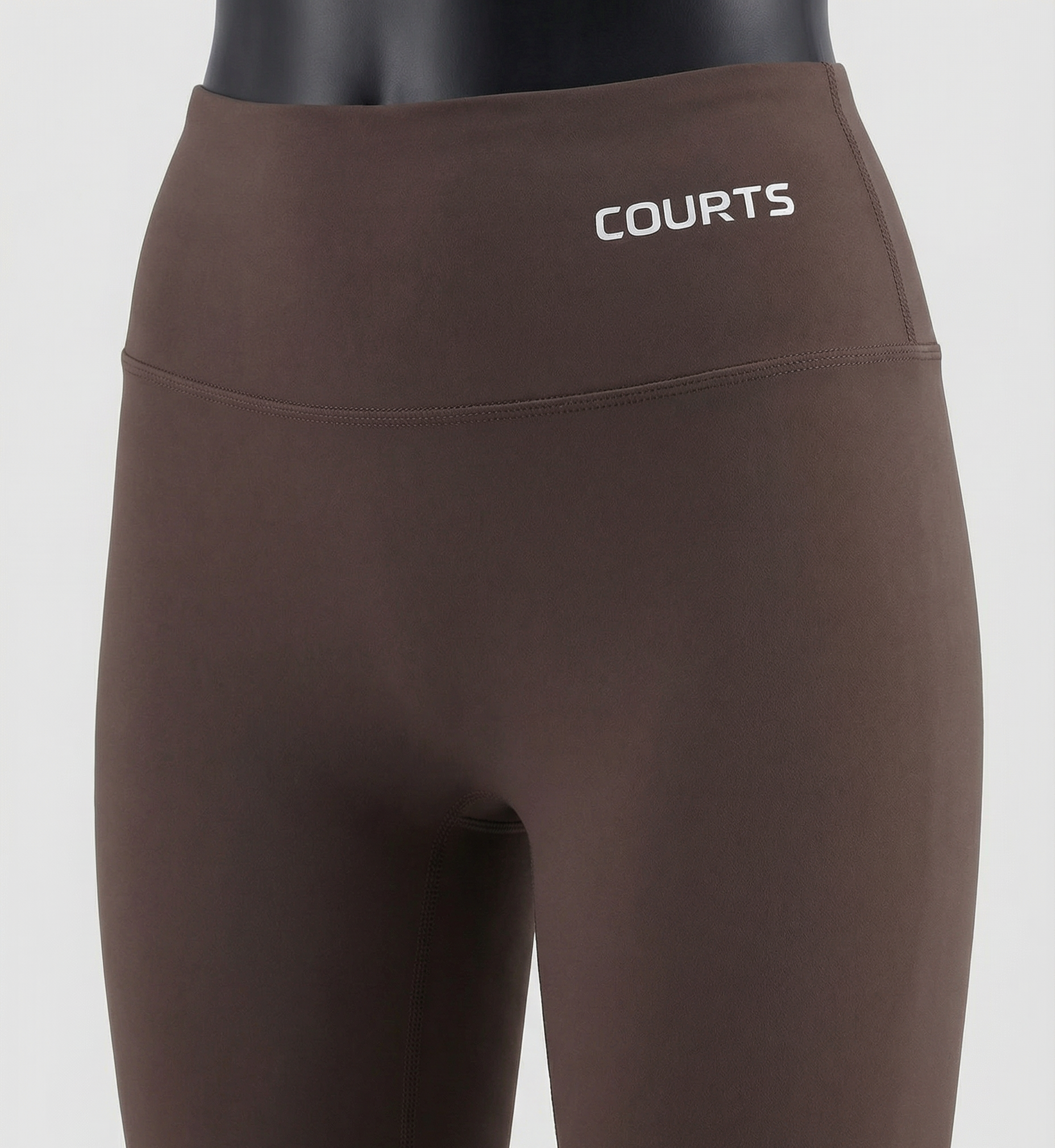 Mannequin wearing a brown skirt and pants with 'Courts' branding on a white background