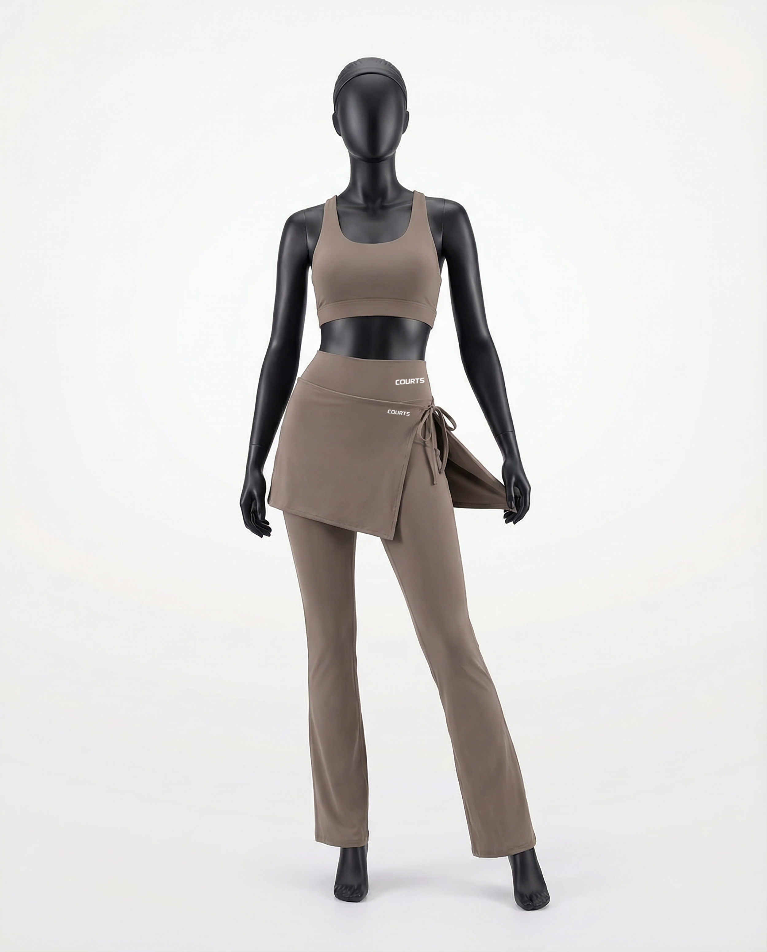 Mannequin wearing a khaki brown skirt and pants with 'Courts' branding on a white background