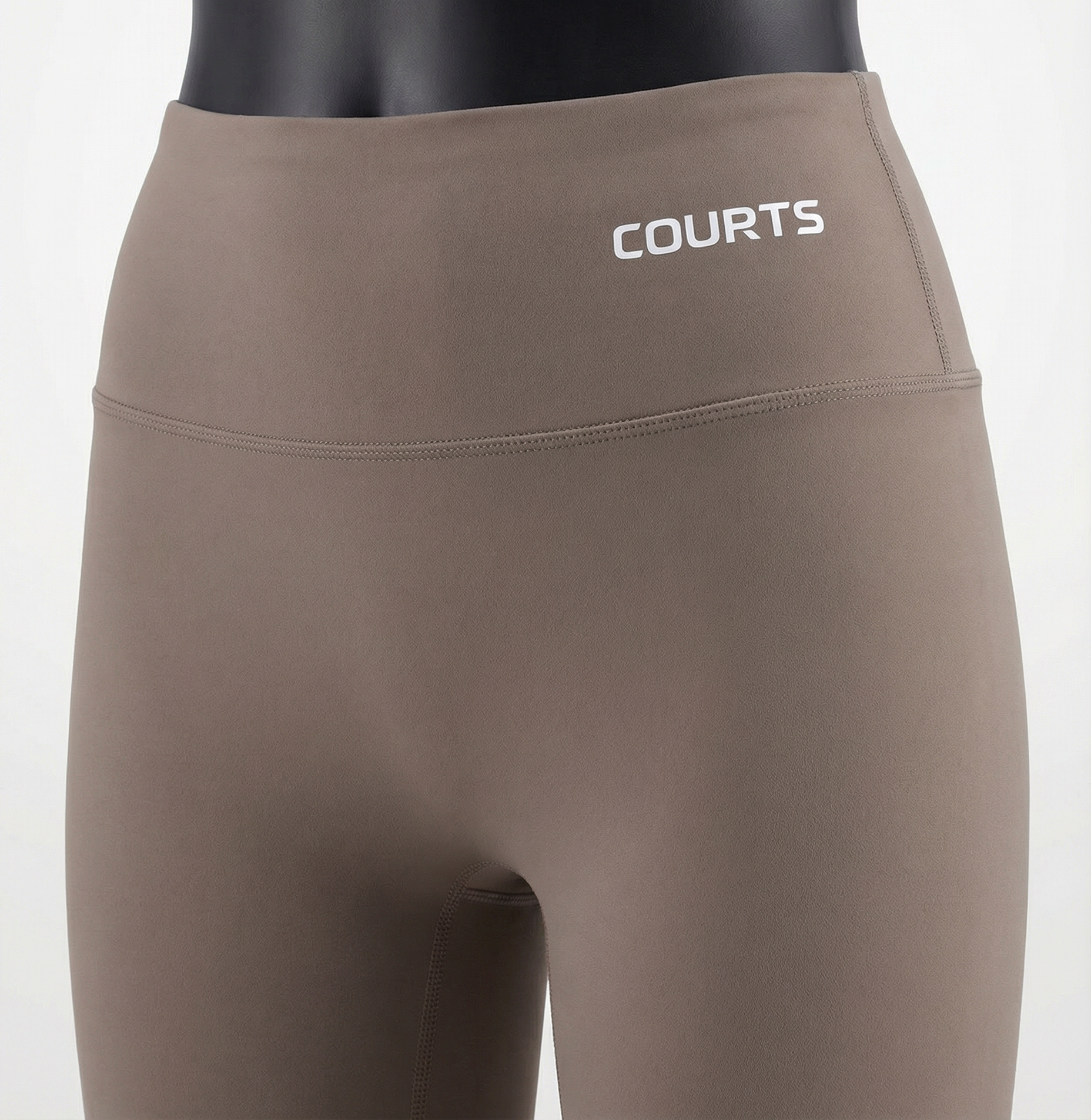 Mannequin wearing a khaki brown skirt and pants with 'Courts' branding on a white background