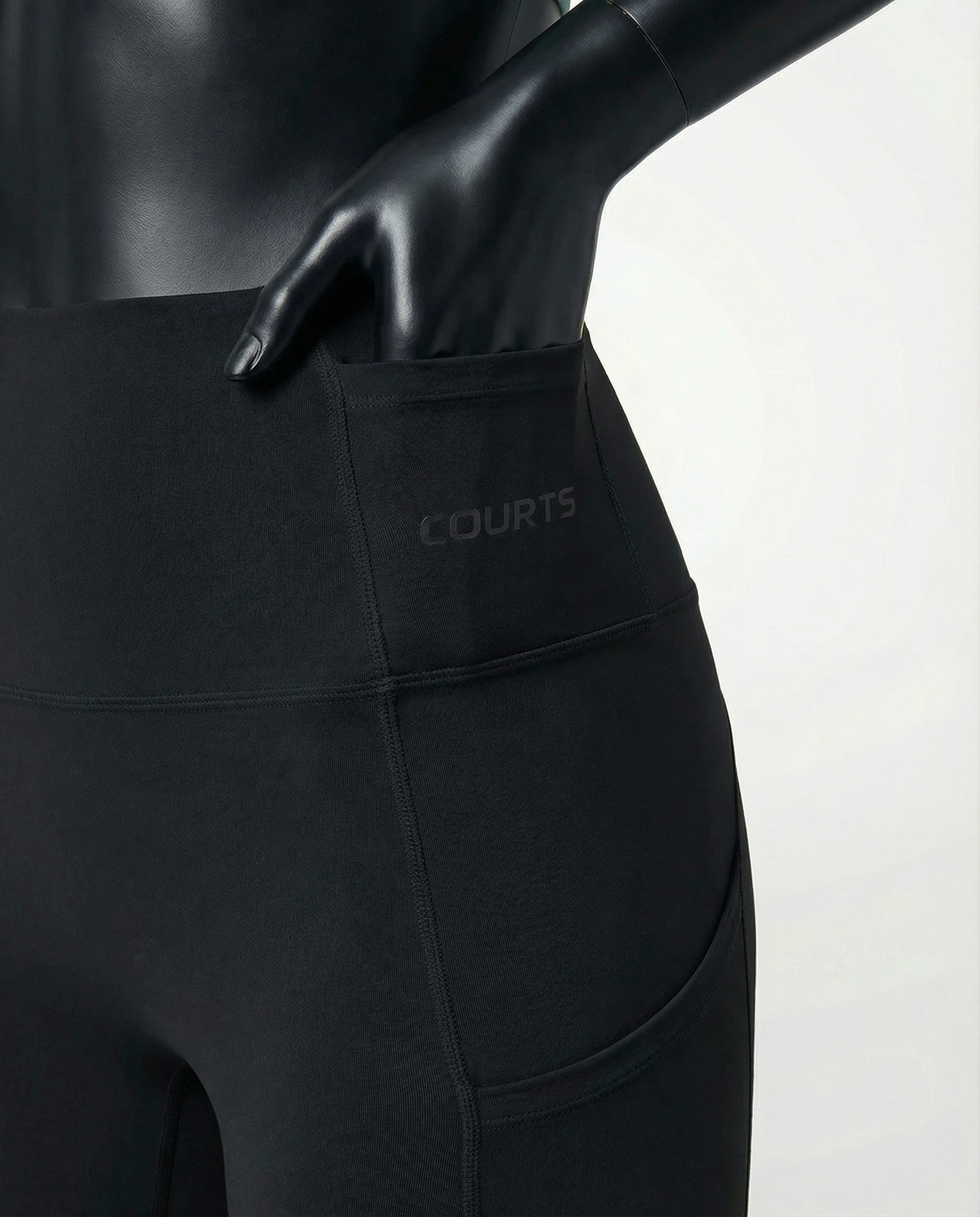 Courts black leggings worn by a mannequin on a white background