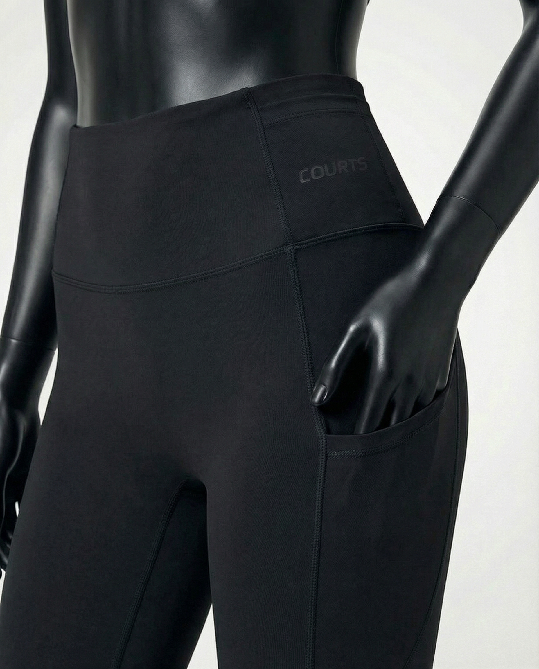 Courts black leggings worn by a mannequin on a white background