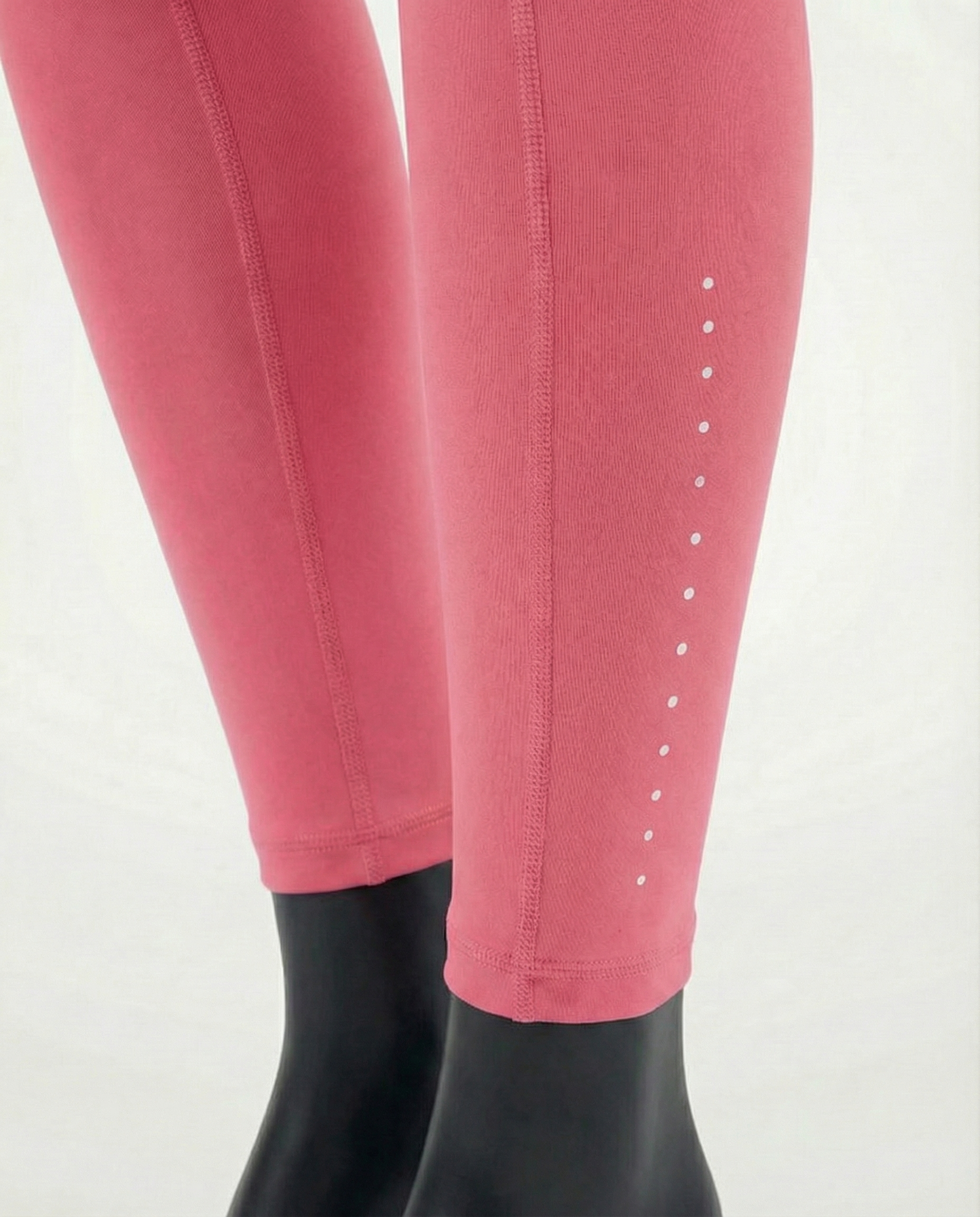 Courts pink leggings worn by a mannequin on a white background