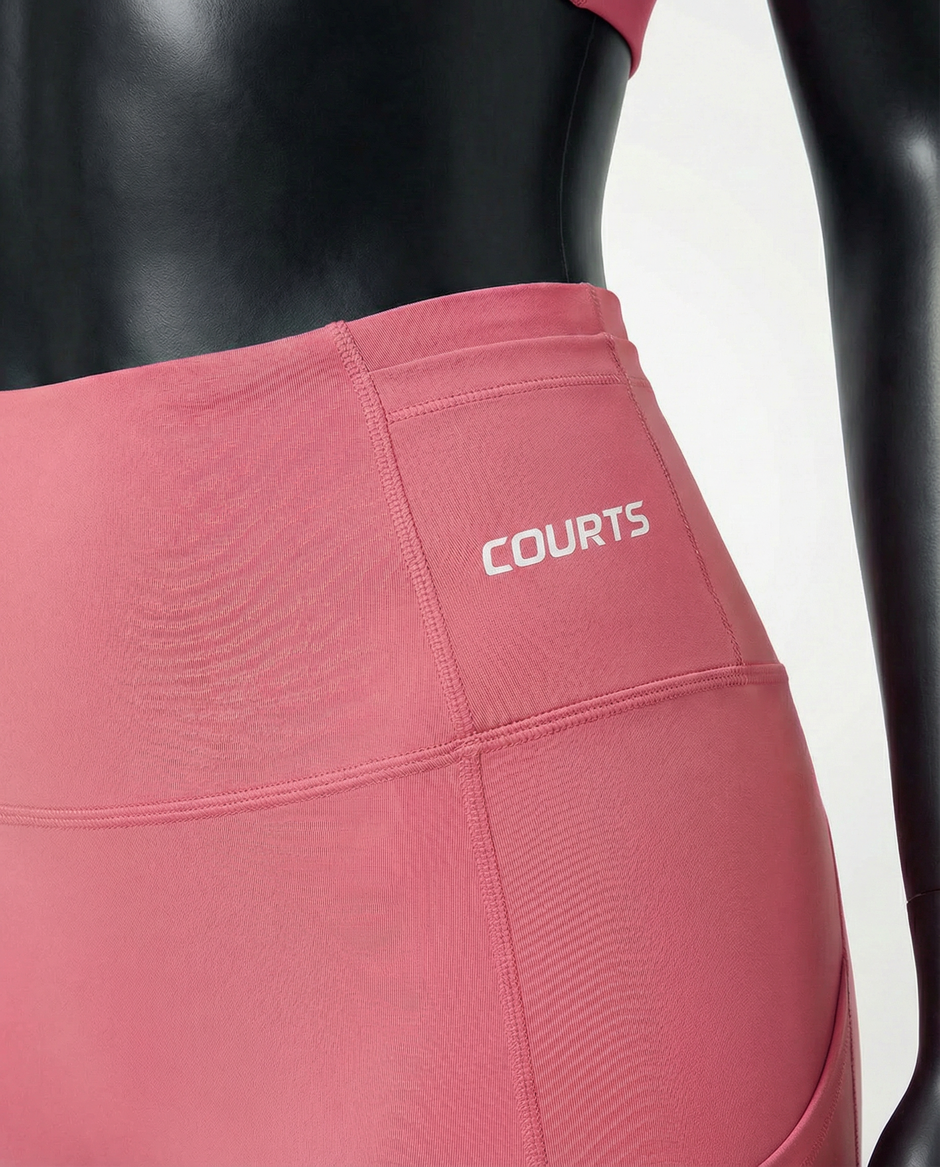 Courts pink leggings worn by a mannequin on a white background