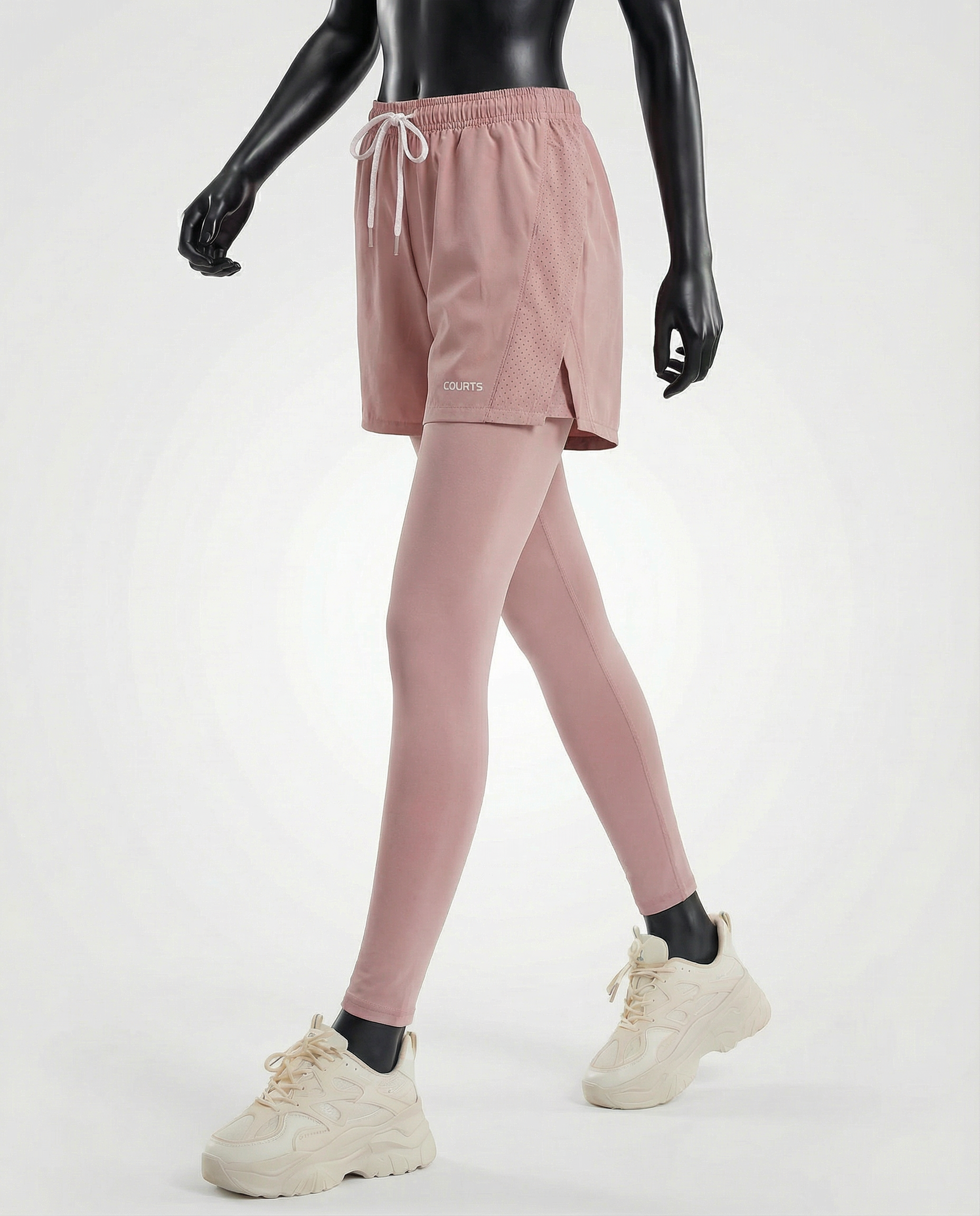 Mannequin wearing pink athletic shorts and leggings with a white background
