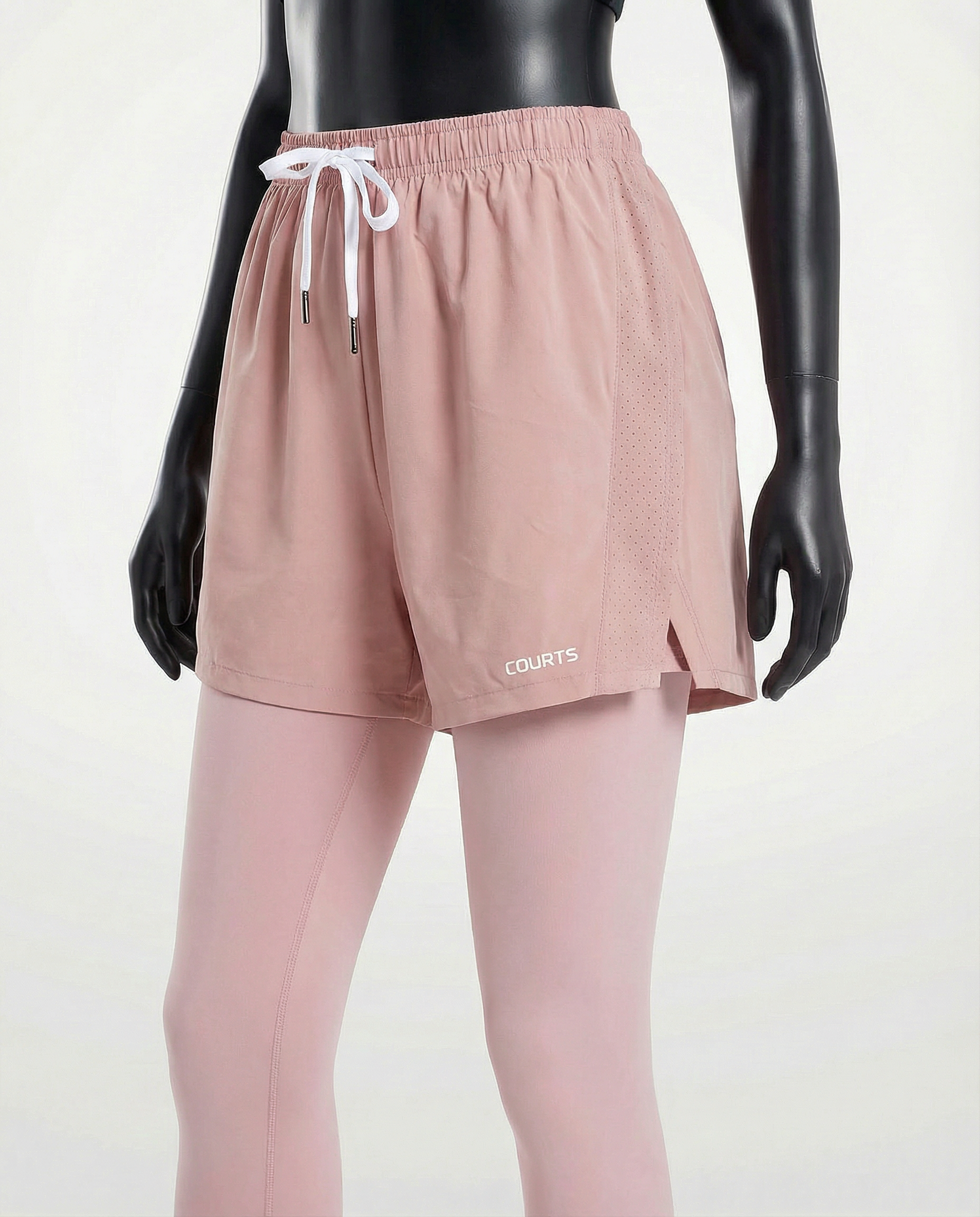Mannequin wearing pink athletic shorts and leggings with a white background