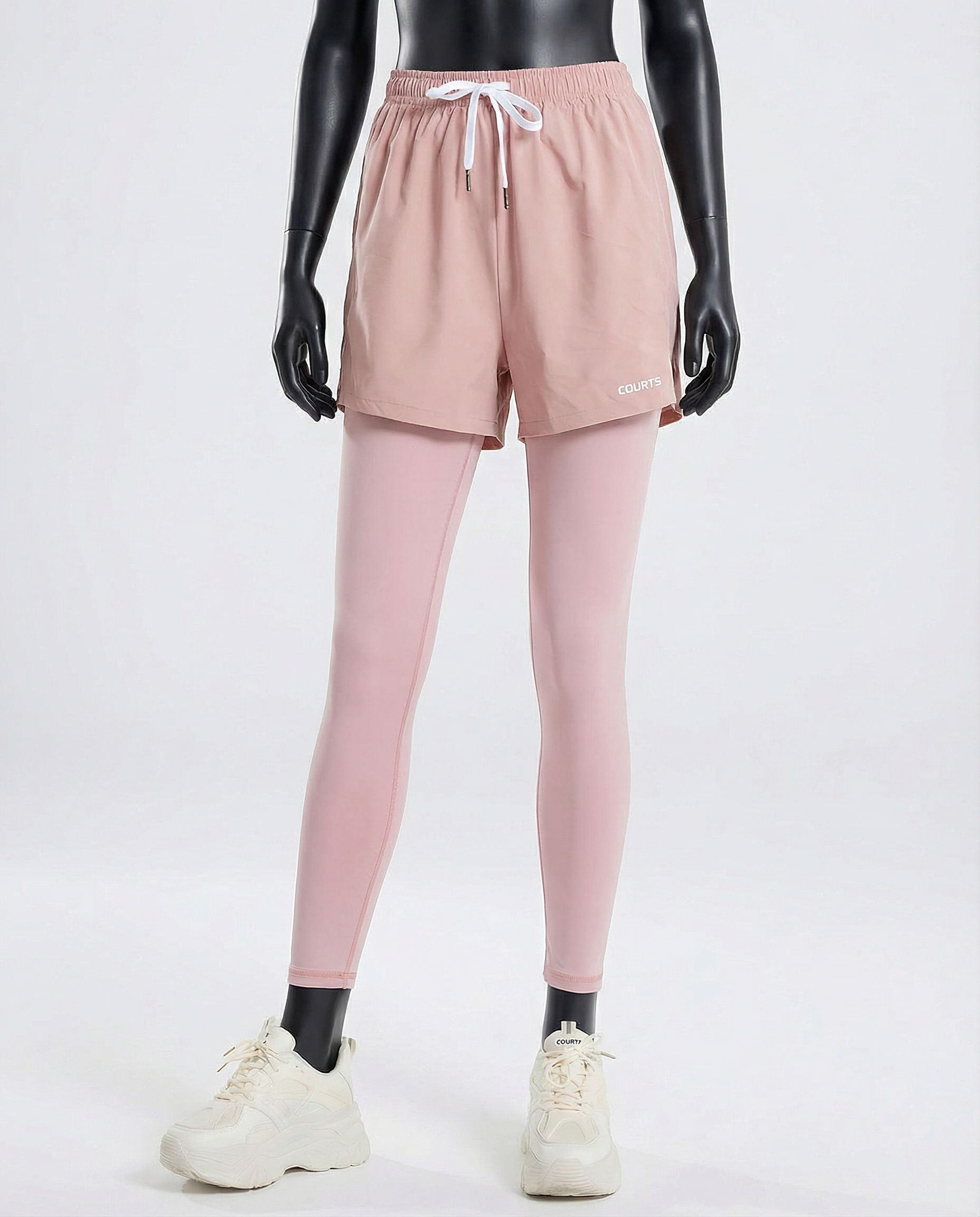 Mannequin wearing pink athletic shorts and leggings with a white background