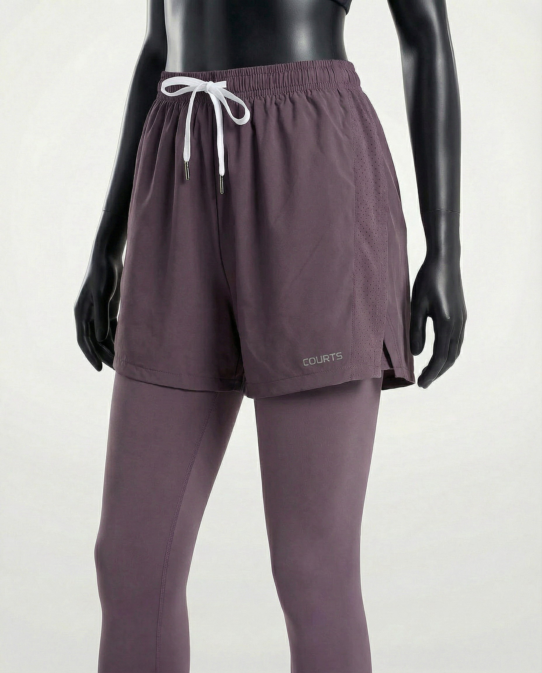 Mannequin wearing purple athletic pants and shoes on a white background