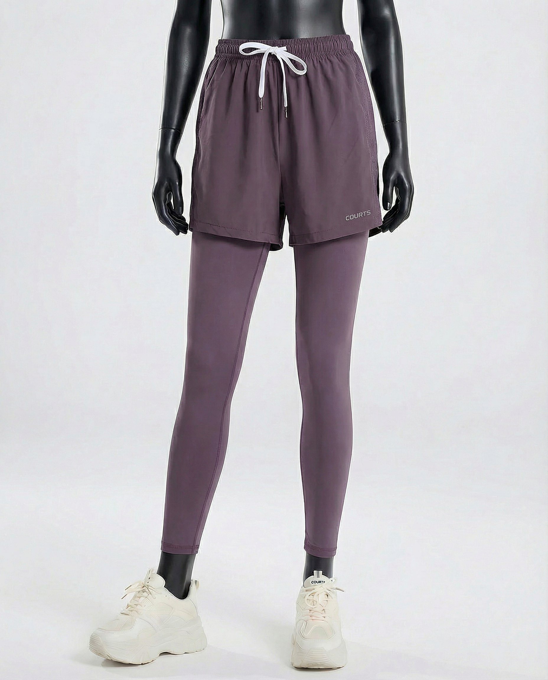 Mannequin wearing purple athletic pants and shoes on a white background