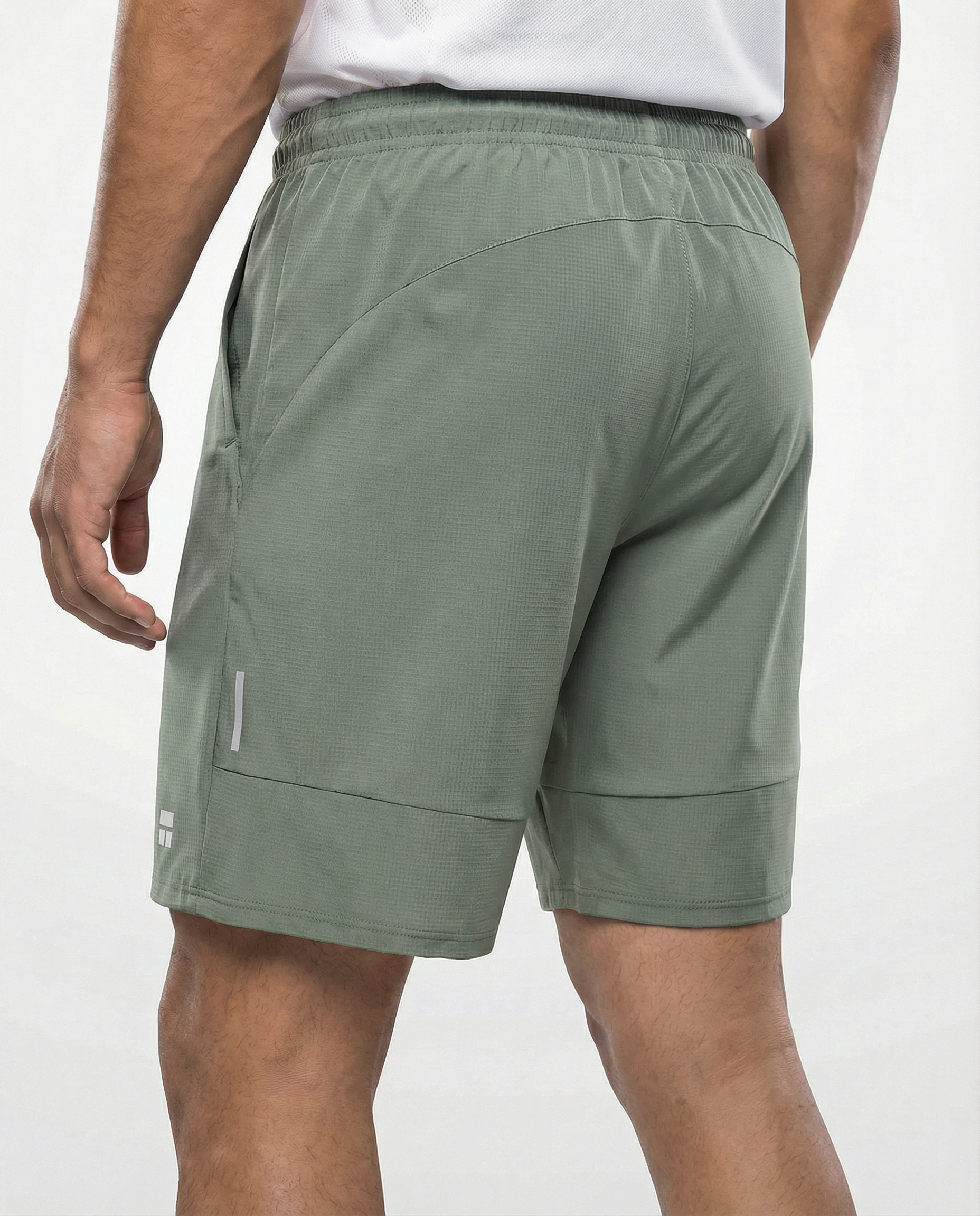 Person wearing Courts sport army green shorts with a white background