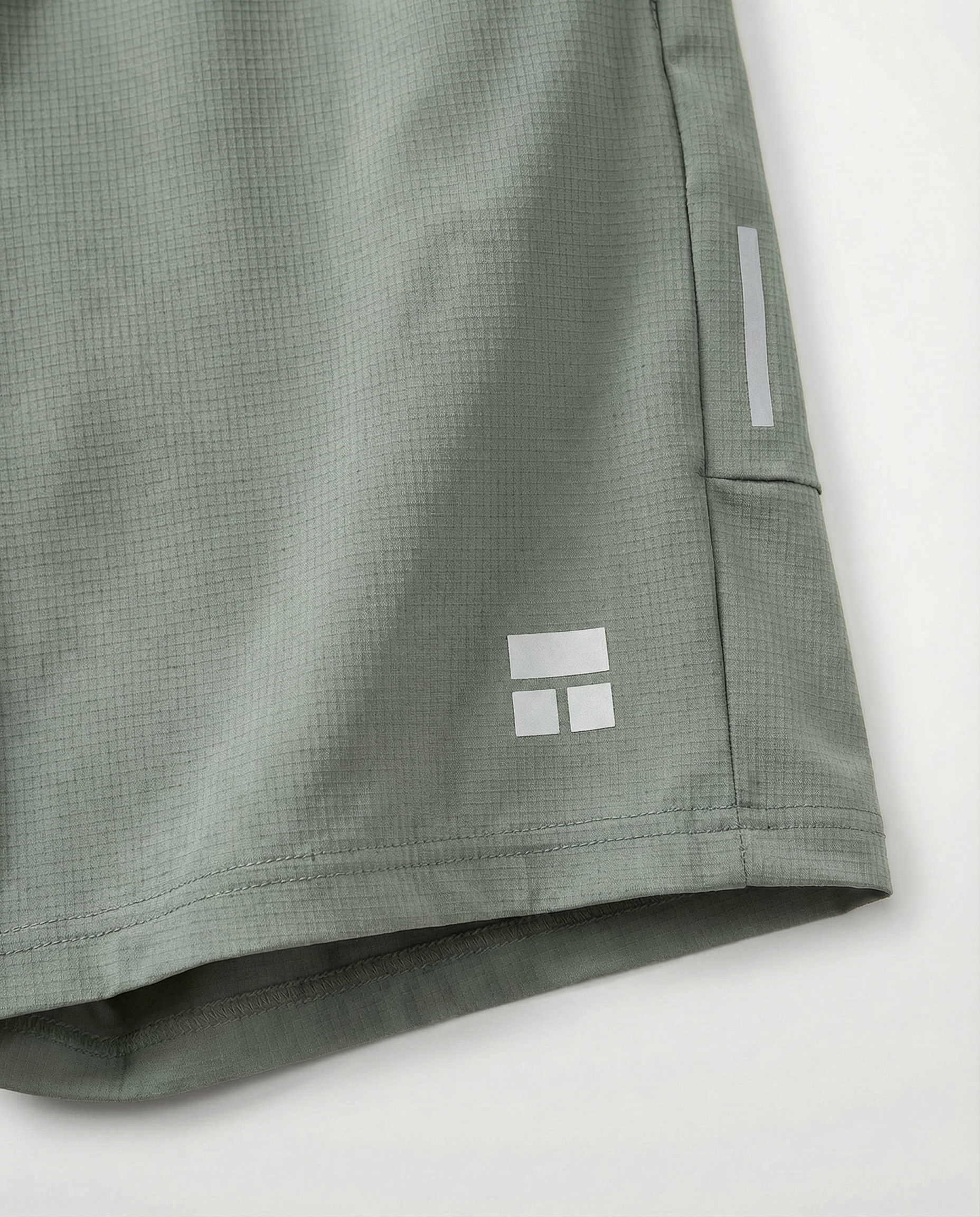 Person wearing Courts sport army green shorts with a white background