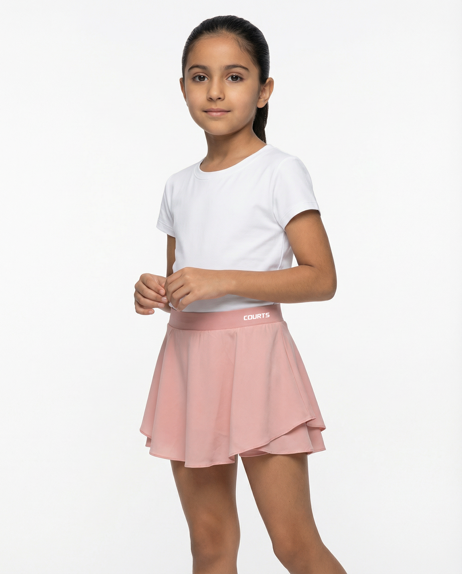 Young girl wearing a white t-shirt and pink skirt skort short on a white background
Courts Sport