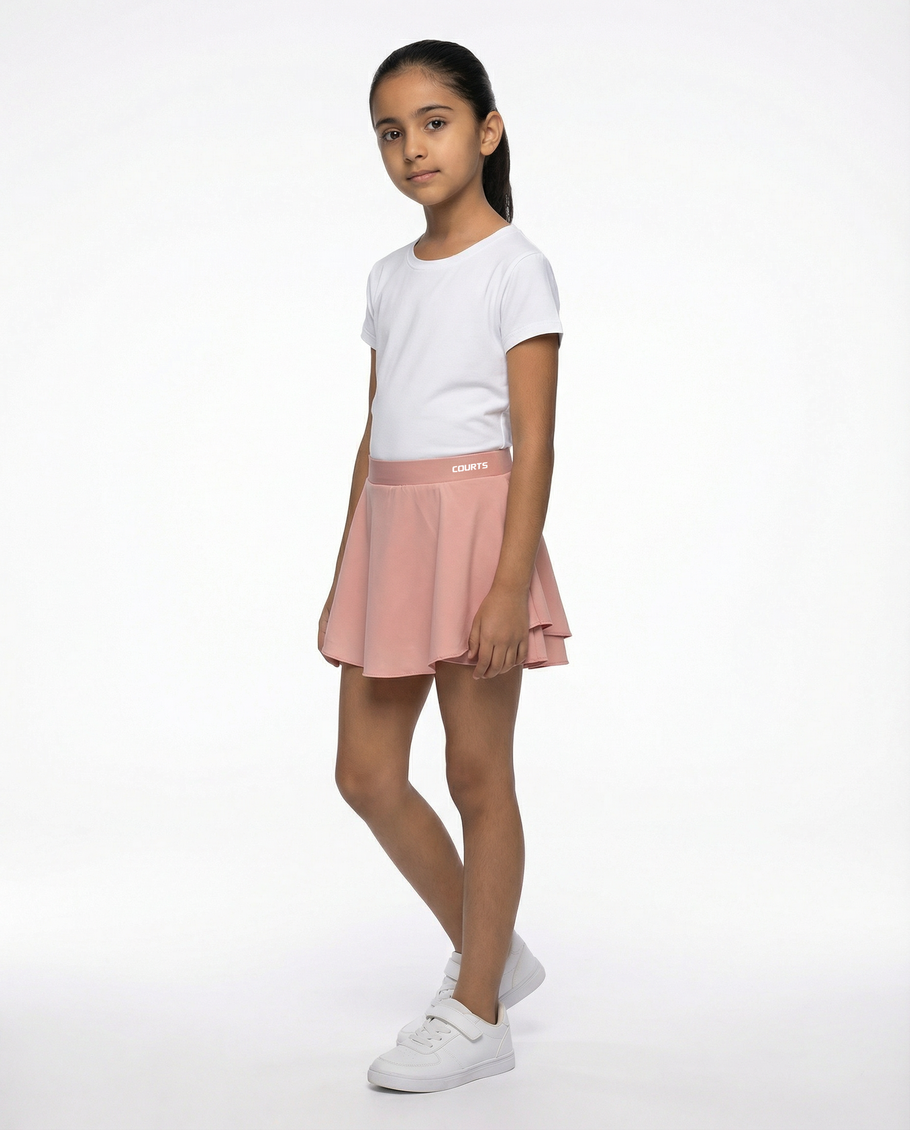 Young girl wearing a white t-shirt and pink skirt skort short on a white background
Courts Sport
