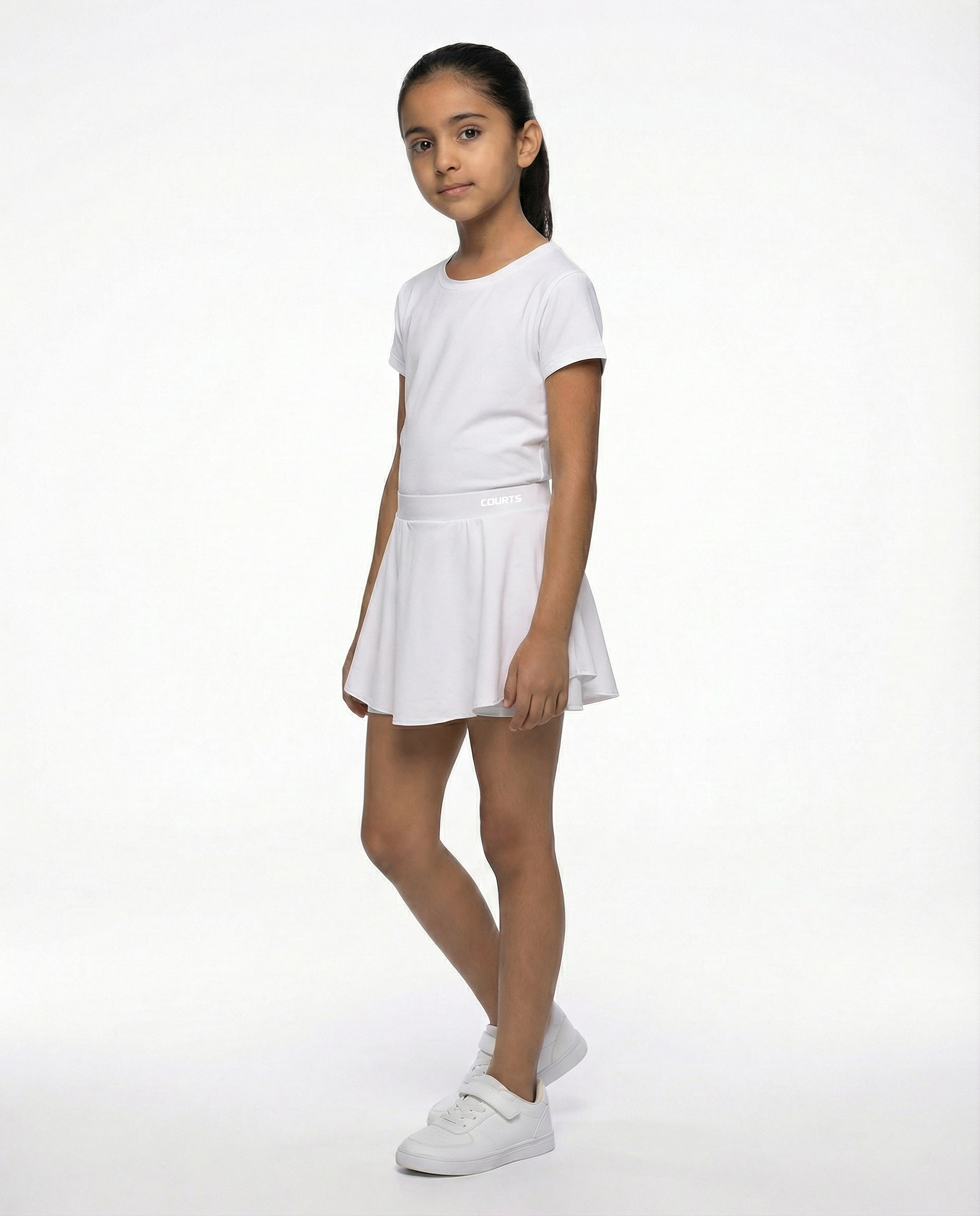 Young girl wearing a white t-shirt and white skirt skort short on a white background
Courts Sport