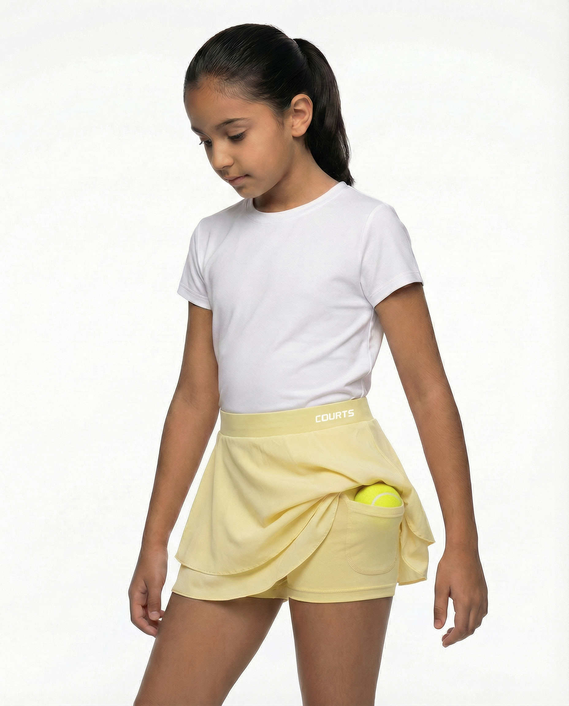 Young girl wearing a white t-shirt and yellow skirt skort short on a white background
Courts Sport