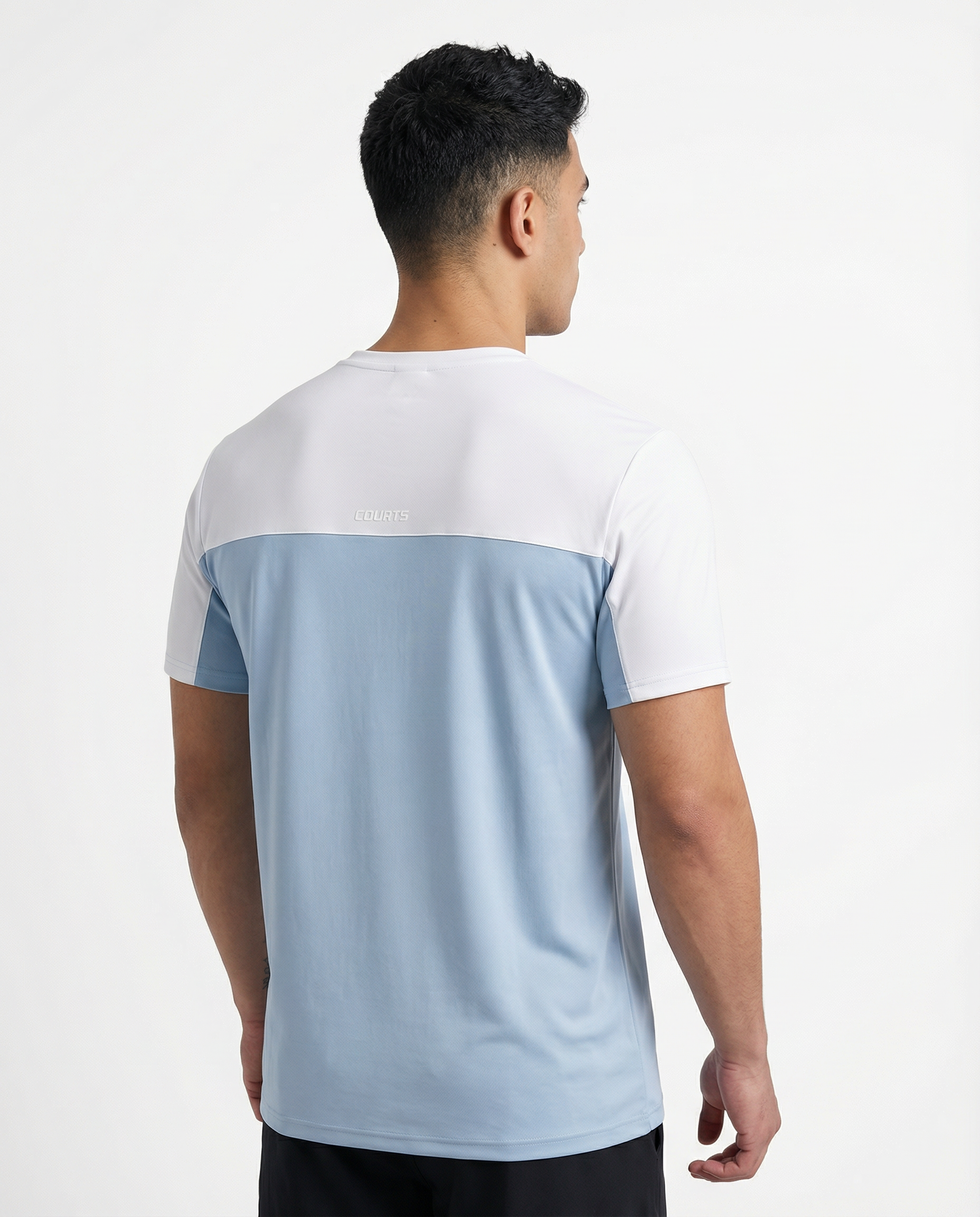 Man wearing a light blue and white t-shirt on a plain background
Courts Sport