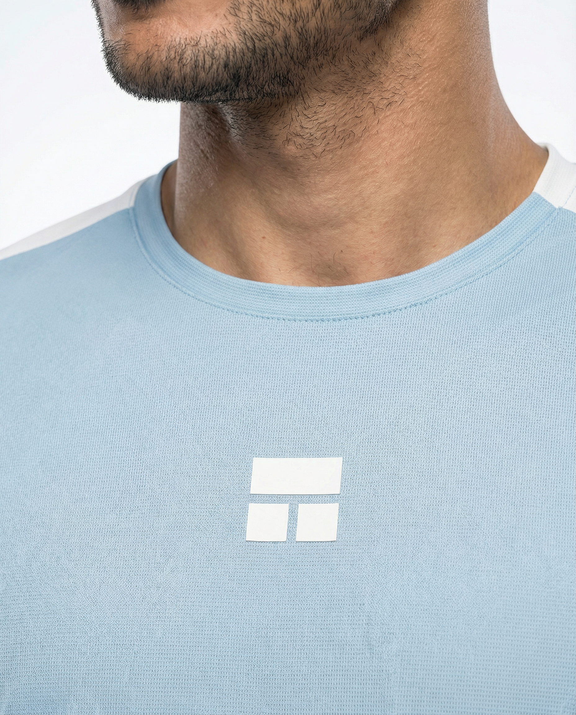 Man wearing a light blue and white t-shirt on a plain background
Courts Sport
