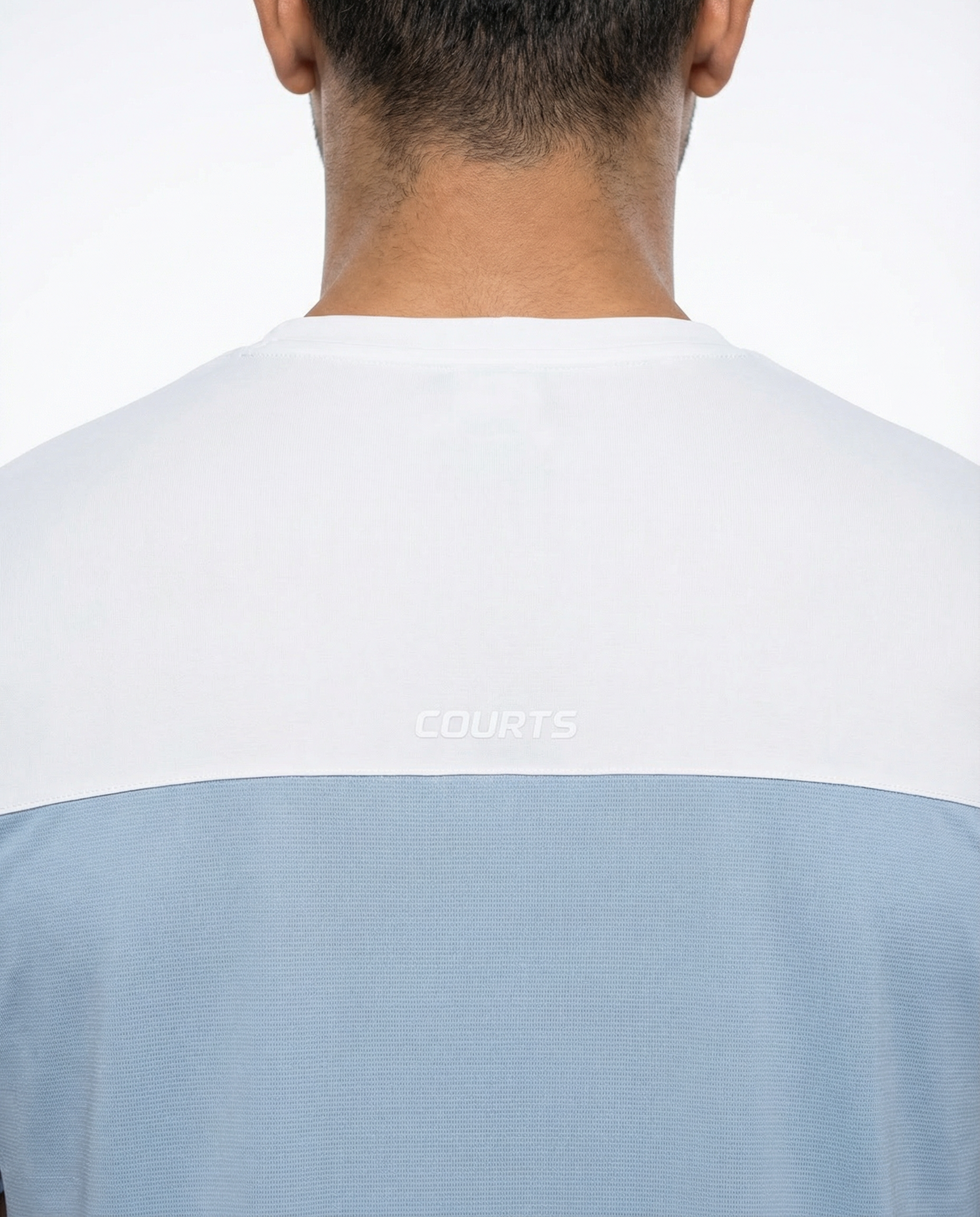 Man wearing a light blue and white t-shirt on a plain background
Courts Sport