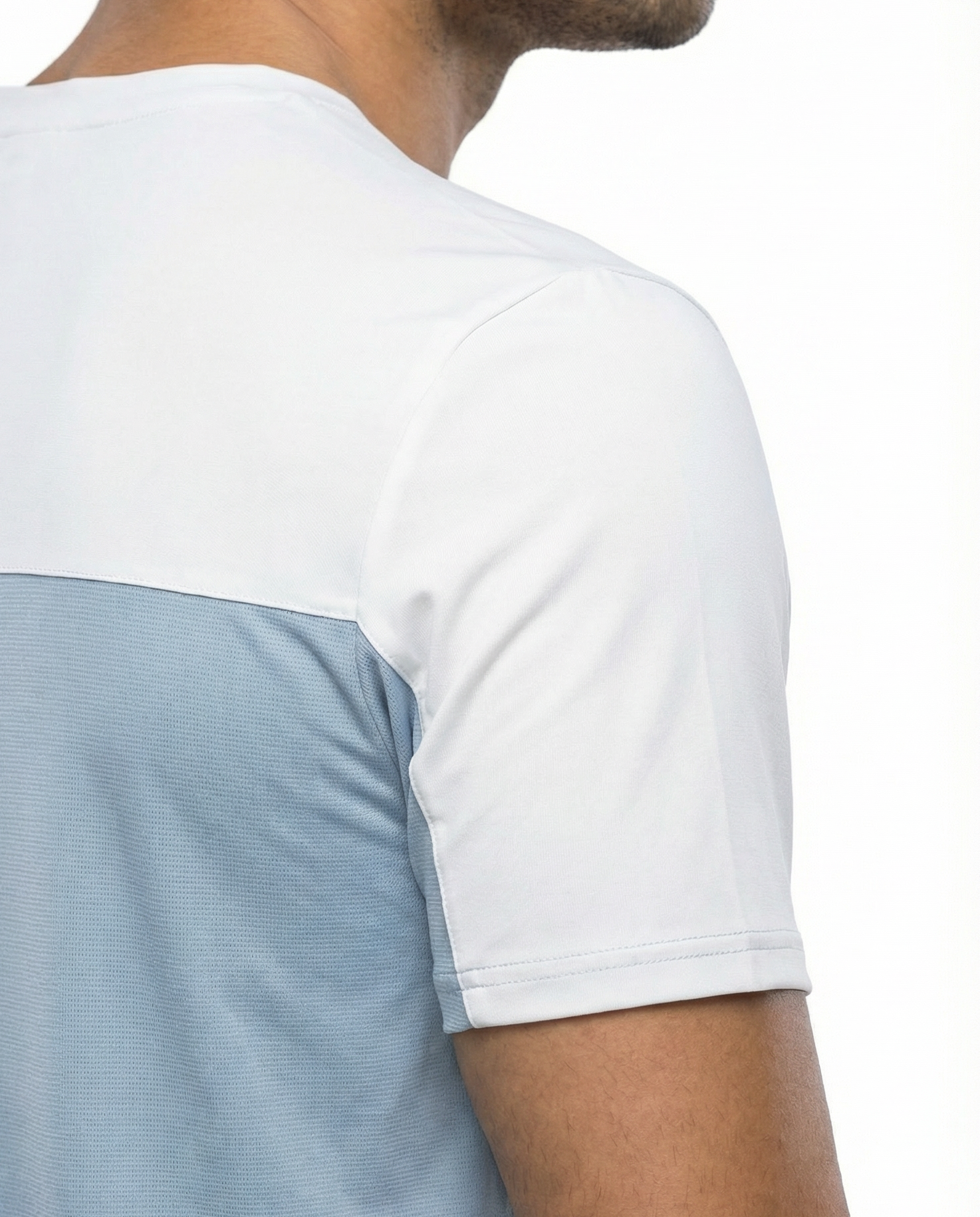 Man wearing a light blue and white t-shirt on a plain background
Courts Sport