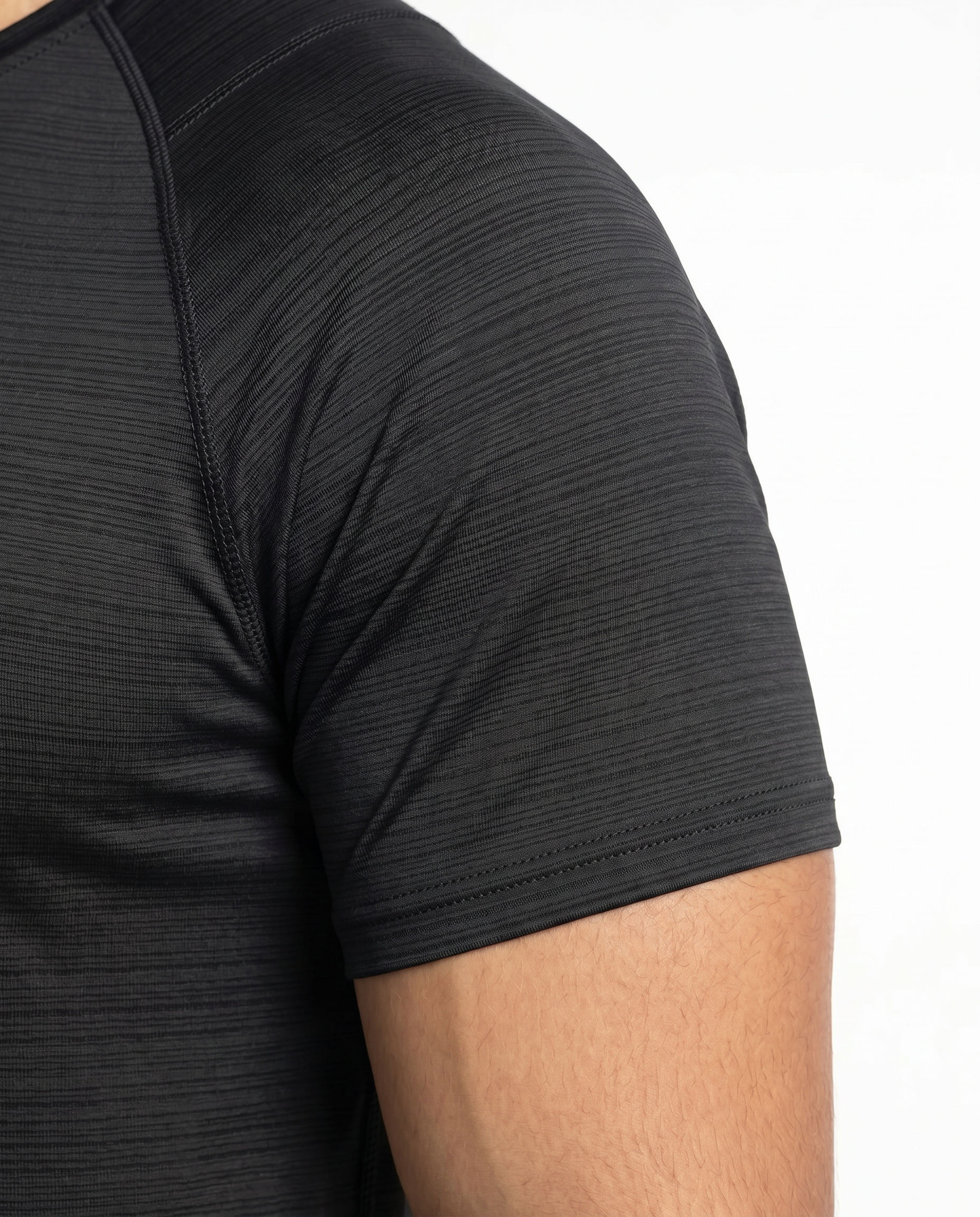 Man wearing a black athletic outfit with a logo on a white background