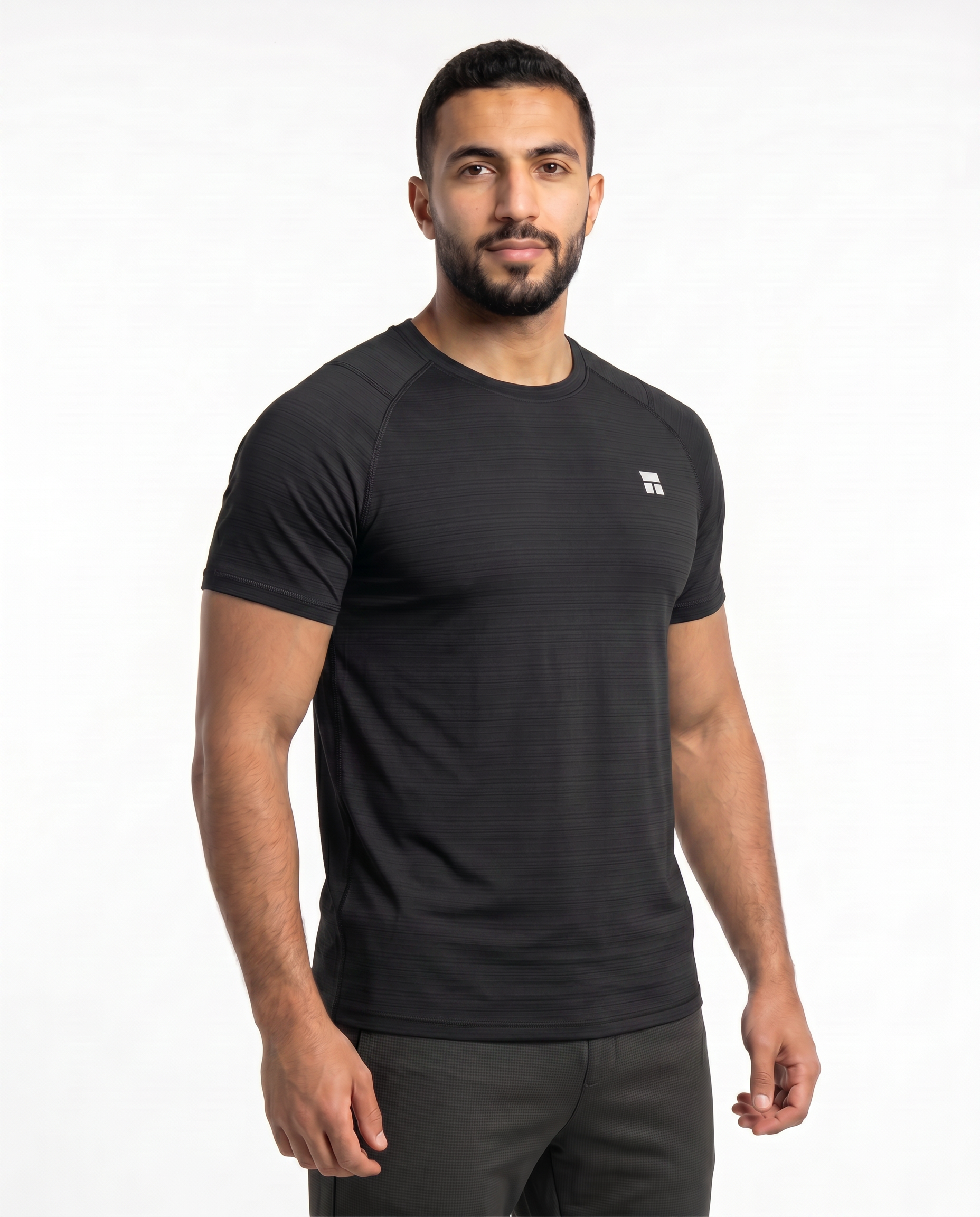 Man wearing a black athletic outfit with a logo on a white background