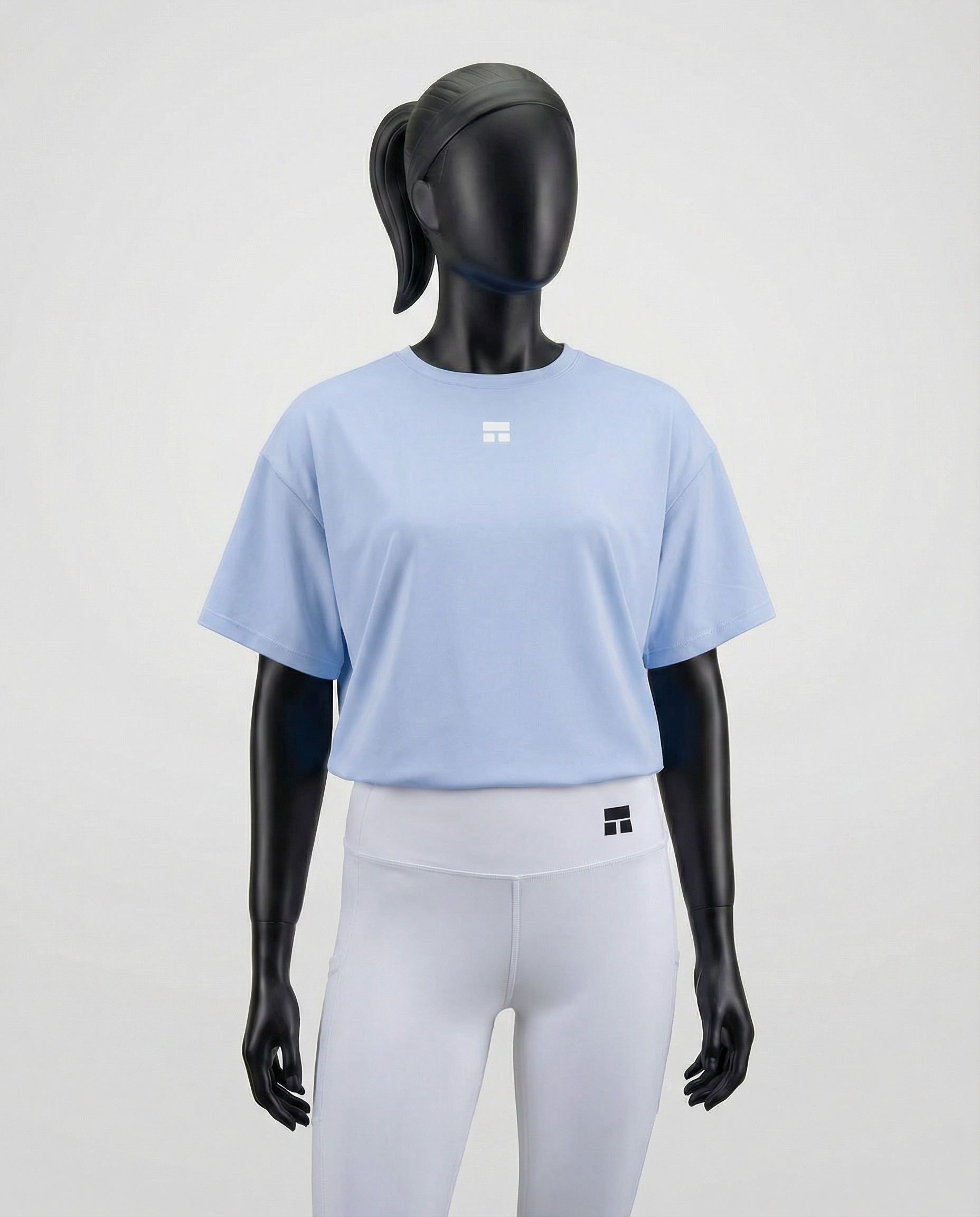 Mannequin wearing an oversized light blue t-shirt on a white background