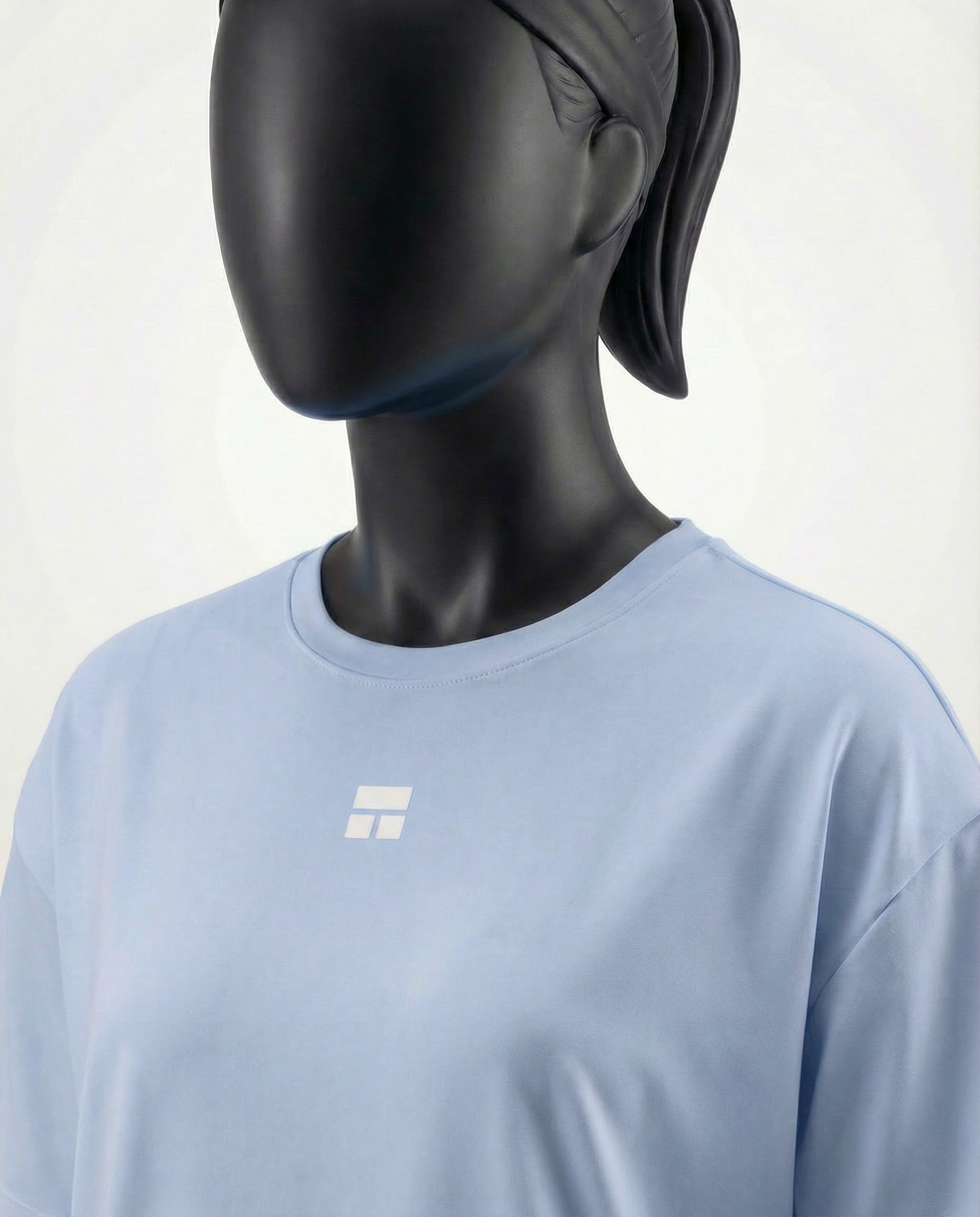 Mannequin wearing an oversized light blue t-shirt on a white background
